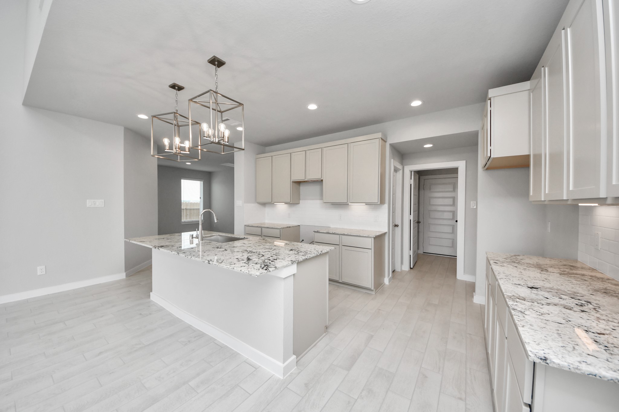 The open concept effortlessly connects the kitchen to the expansive family room, forming a perfect hub for gatherings. This seamless flow creates an inviting space where cooking and socializing come together harmoniously. Sample photo of completed home with similar floor plan. Actual colors and selections may vary.