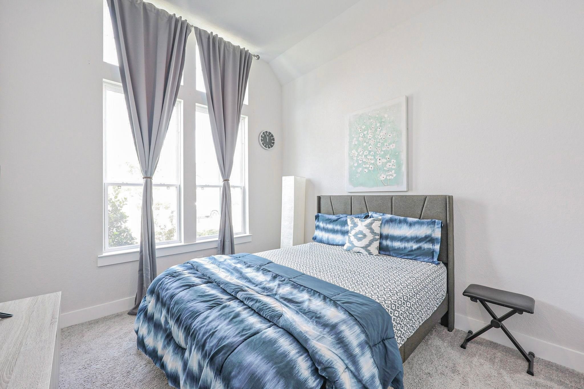 Inviting secondary bedroom on 1st floor featuring large windows giving the view of well manicured lawn of the front yard.