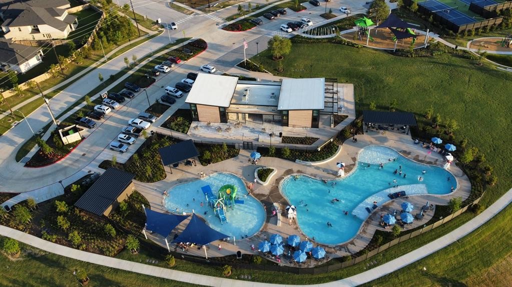 THE LANDING amenity center is within walking distance of the home and features pools, a splash pad, and a water slide, along with adjacent tennis courts and a playground.