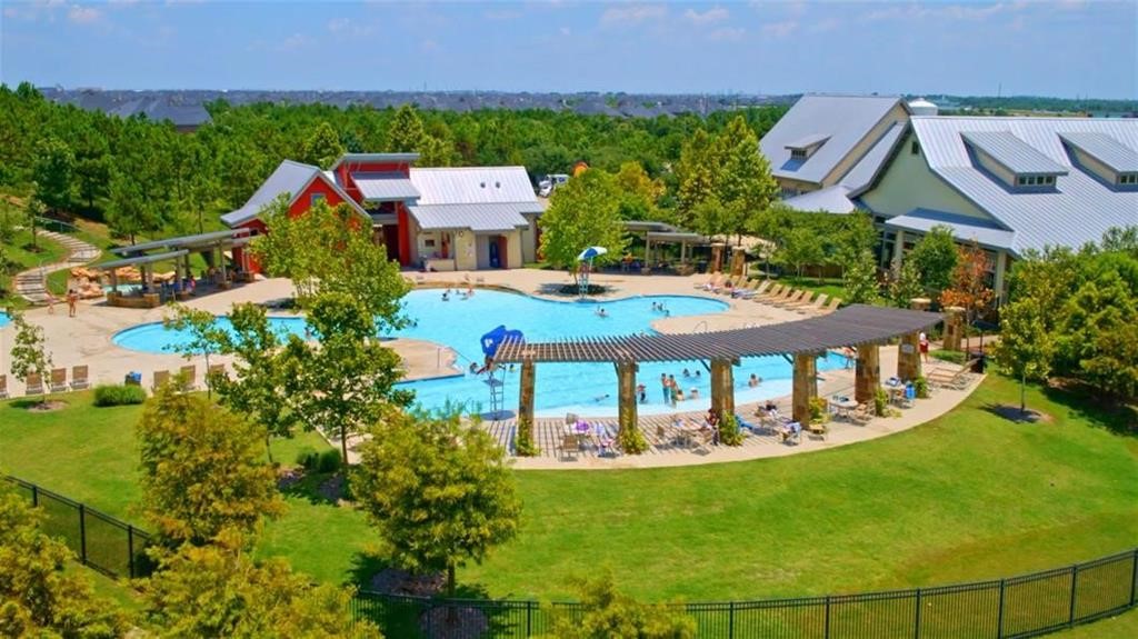 Experience resort-style living with a stunning community pool, surrounded by lush greenery and modern amenities, perfect for relaxation and entertainment.