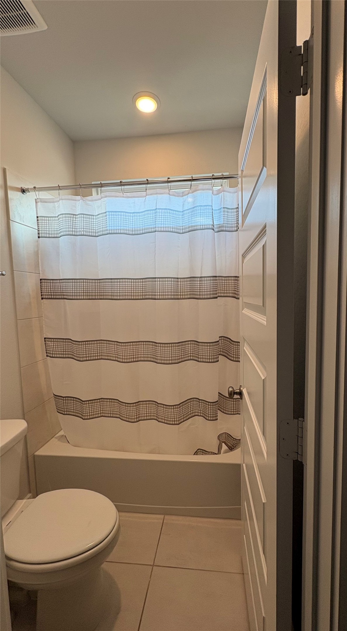 View of the secondary bathroom on 2nd floor. Equipped with double vanity and a tub and shower and window on top of tub.