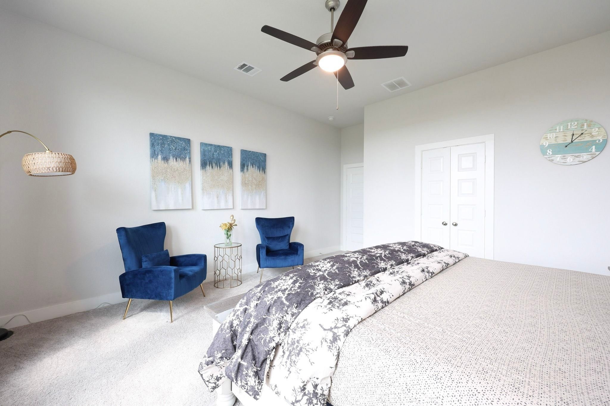 Spacious primary bedroom with a ceiling fan, creating a serene and inviting atmosphere.