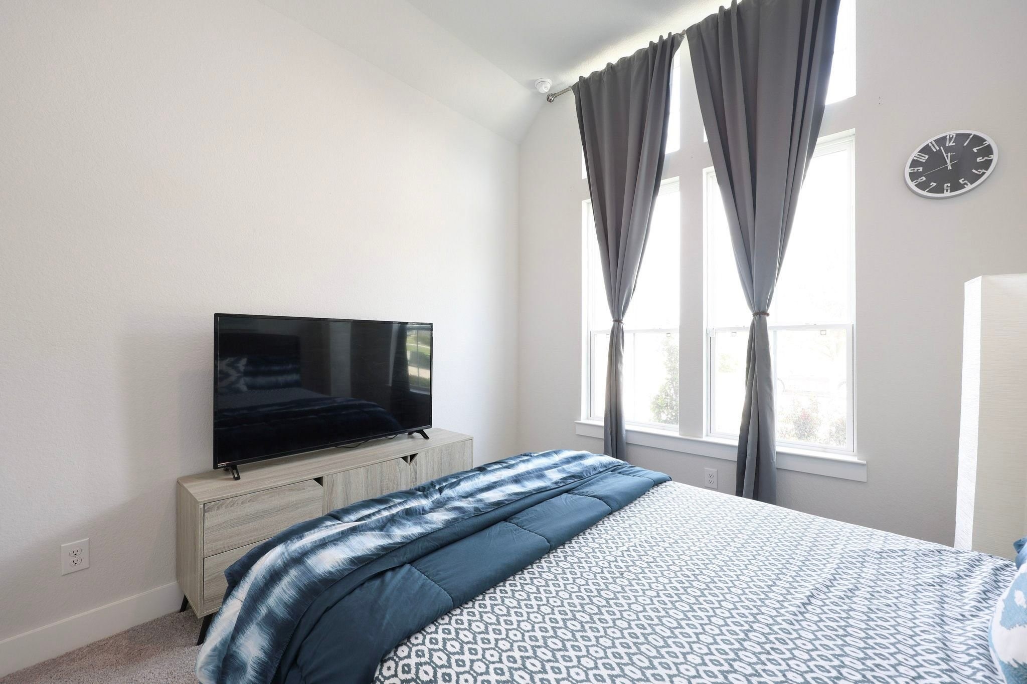 Bright secondary bedroom on 1st floor tucked on the right side of the house upon entry featuring floor to wall windows.