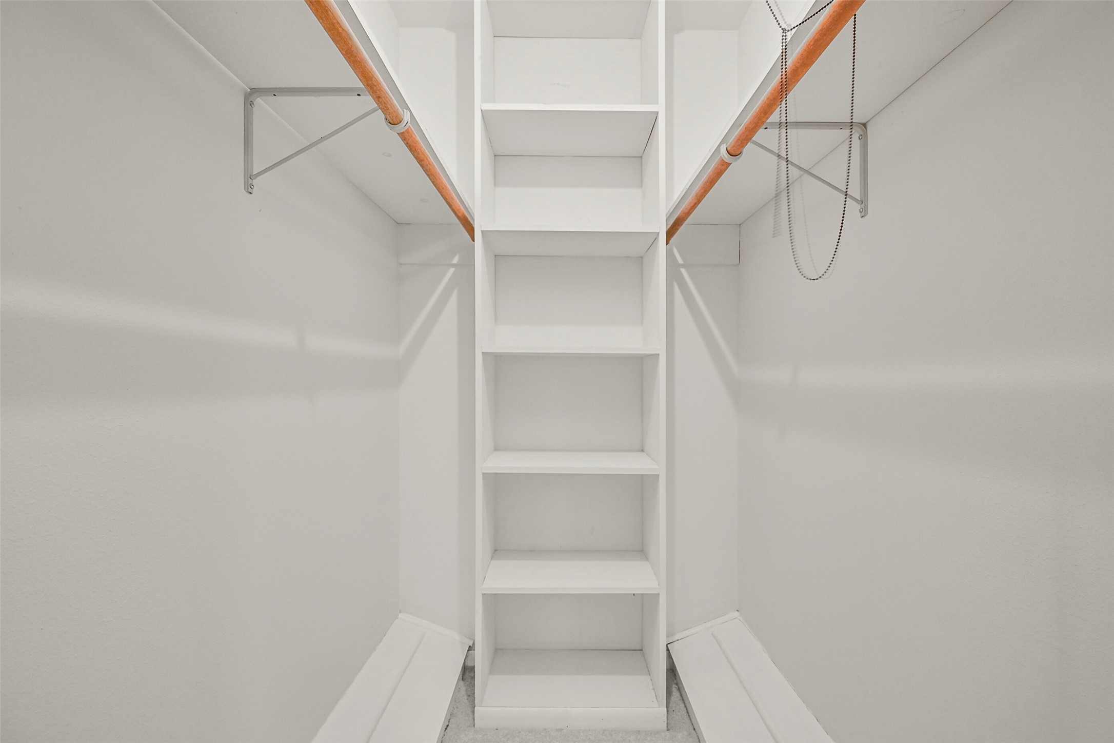 Primary bedroom walk in closet