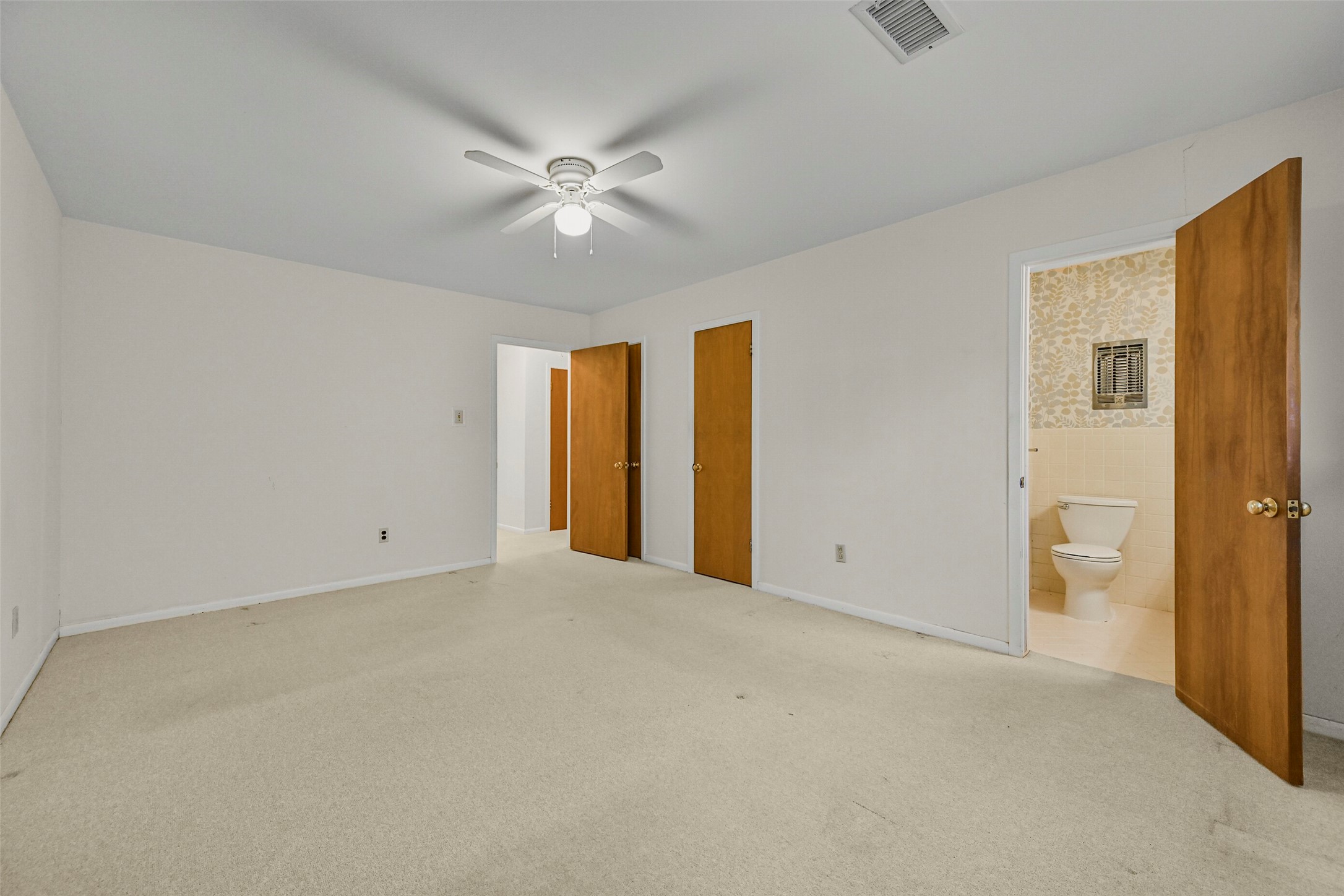 Primary bedroom with 2 walk in closets and an ensuite