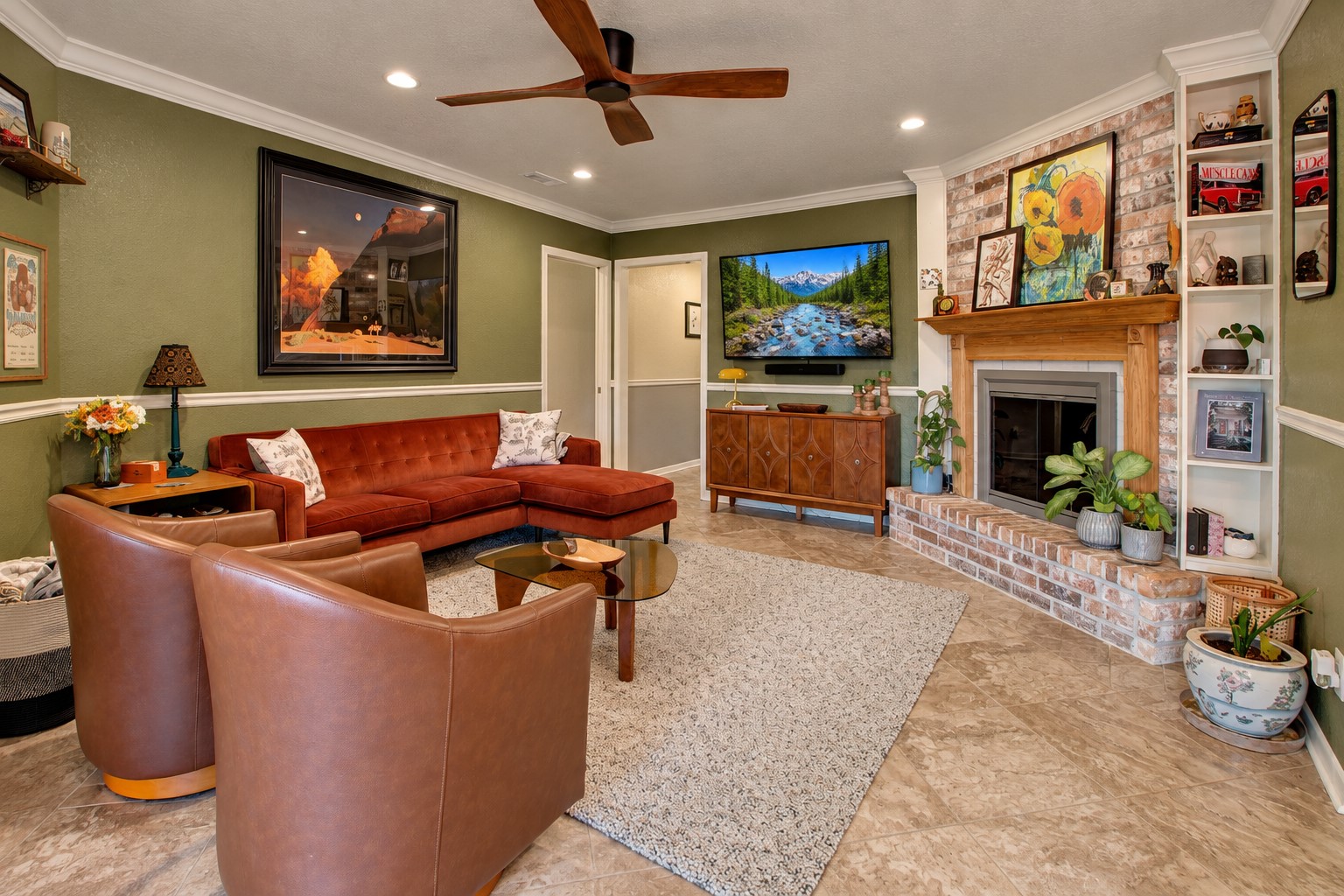 This living room features great natural light, a wood burning fireplace, and built in shelving.