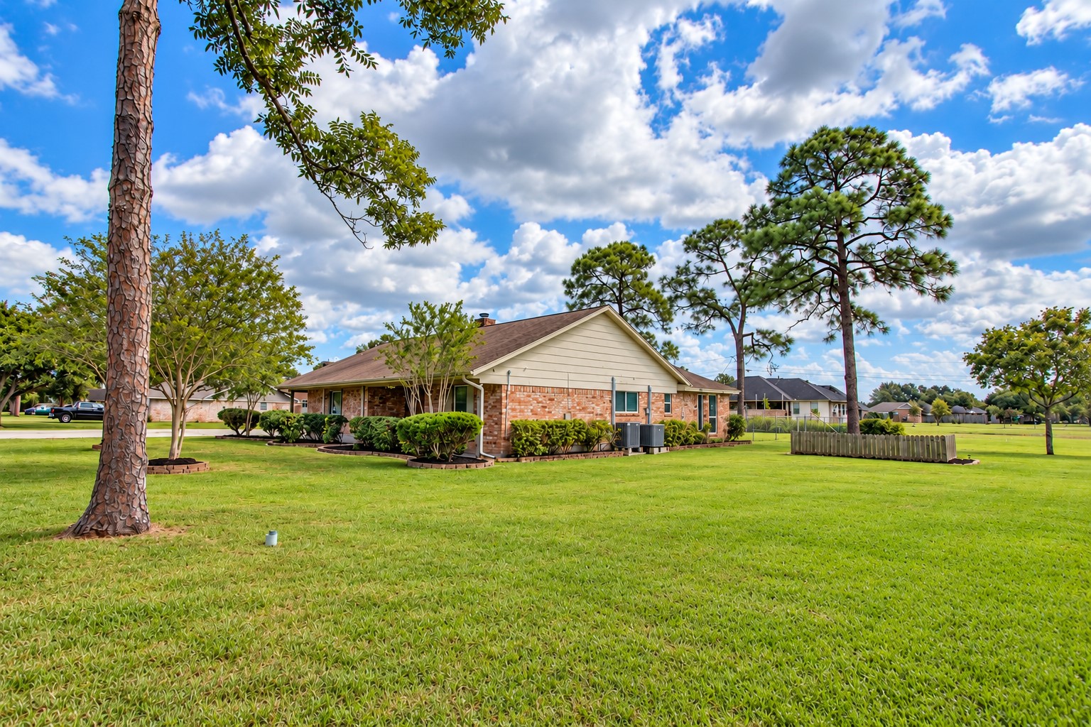 Enjoy the peaceful setting with mature pine trees throughout the property, adding natural character to the expansive yard.