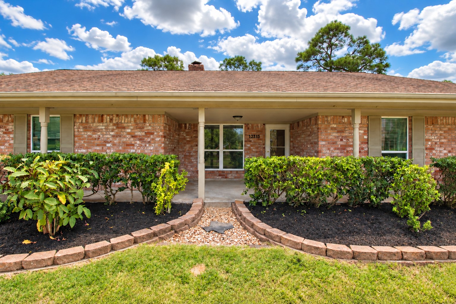 Come on in! A covered front porch and landscaped walkway welcome you home.