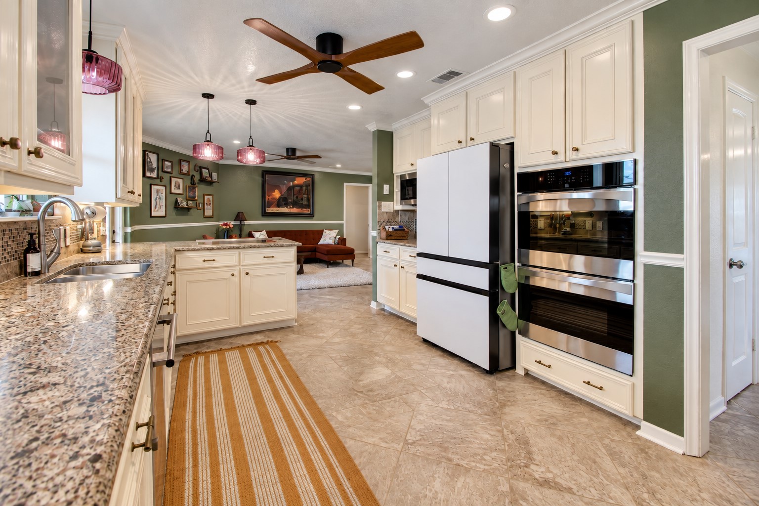 Plenty of space to work with here! Including a convenient double oven and lots of cabinet and counter space. It opens right into the living rooms, giving the whole area a nice, connected feel.