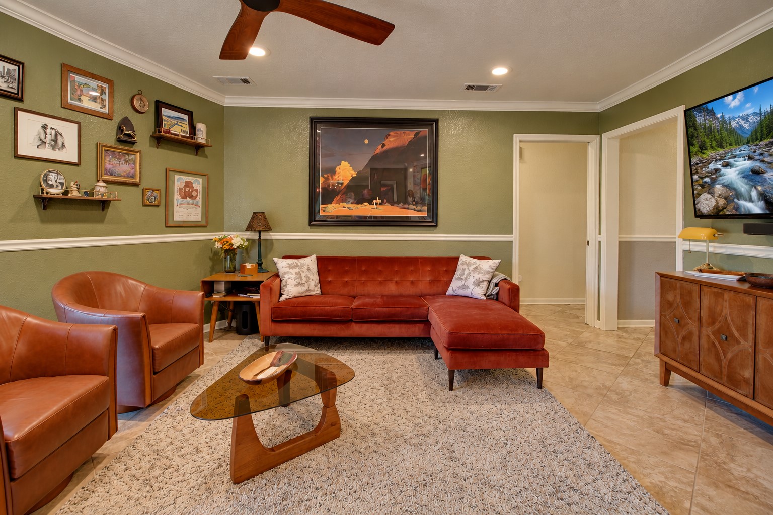 This living room offers a comfortable, inviting space with plenty of seating and a nice amount of natural light. The open layout and warm finishes make it a great space for relaxing or entertaining.