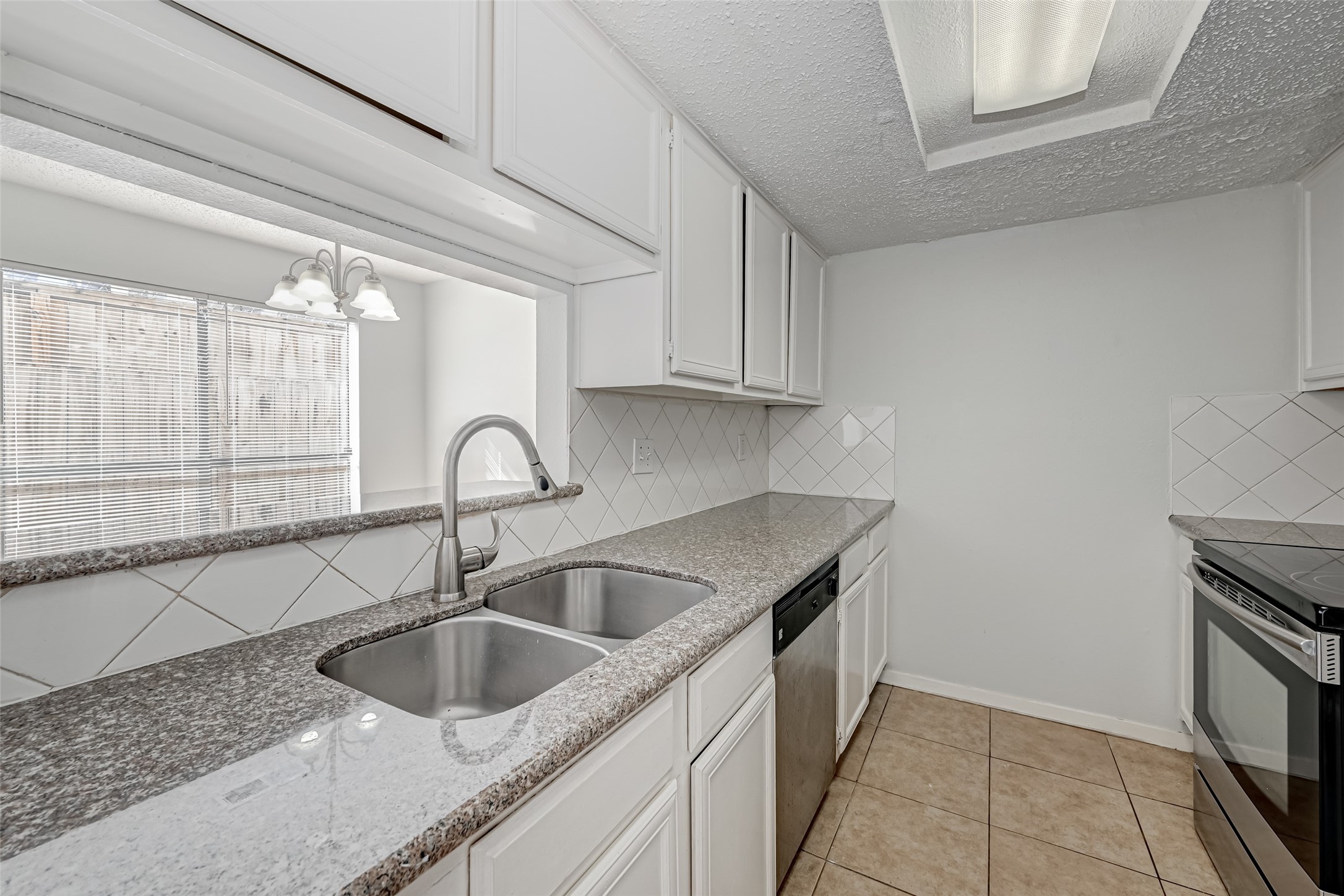 Kitchen with double sinks and granite countertops