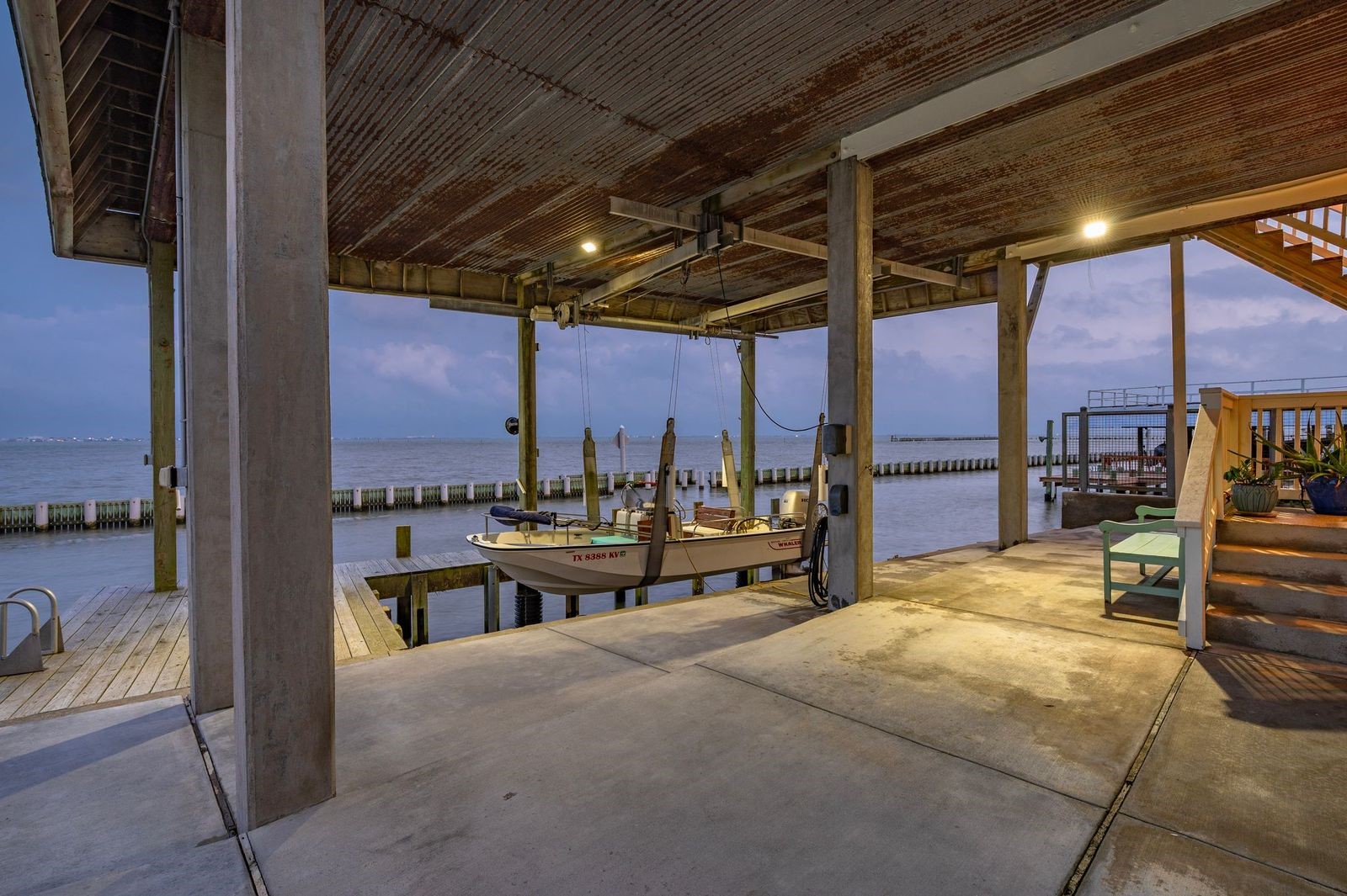 Enjoy Your Boat Day or Night! Property boasts concrete bulkhead with boat house/decking and lift featuring 9 "wellers" for the pier; enjoy fishing Galveston Bay with deep water access direct to the Gulf of America. Enjoy Your Boat Day or Night! Property boasts concrete bulkhead with boat house/decking and lift featuring 9 "wellers" for the pier; enjoy fishing Galveston Bay with deep water access direct to the Gulf of America.