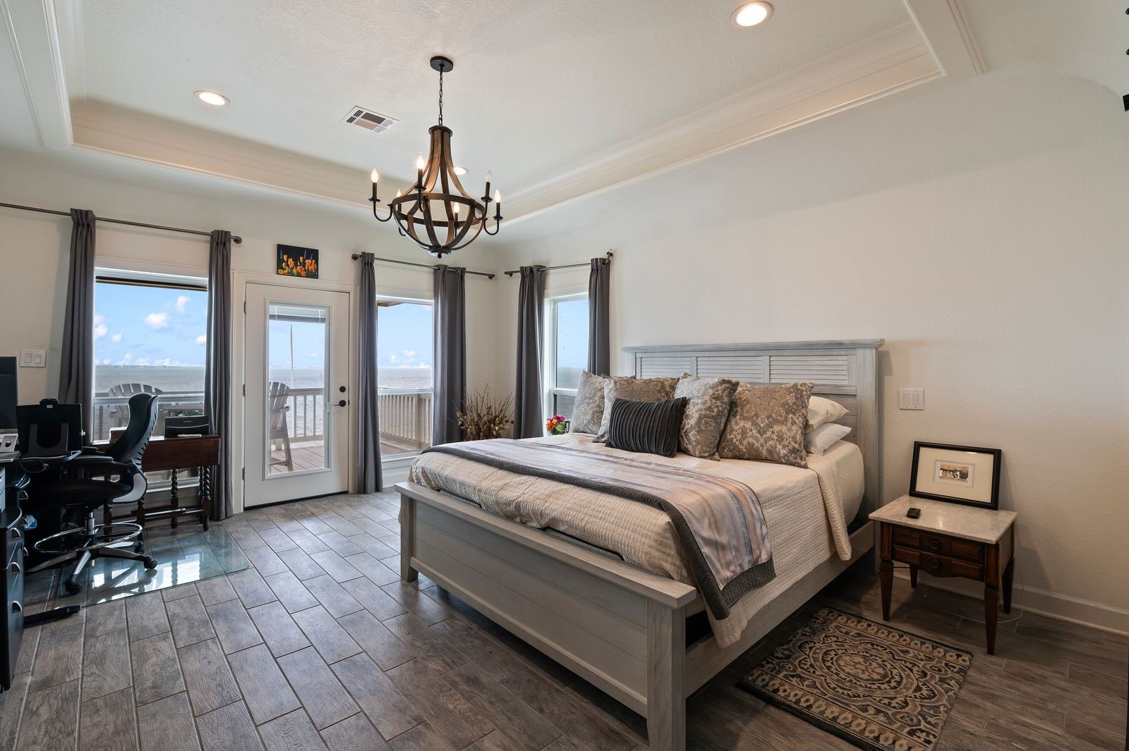 Comfortable, Quiet, Luxury!  Large Primary bedroom with private patio offering serene sunsets and amazing waterfront views.