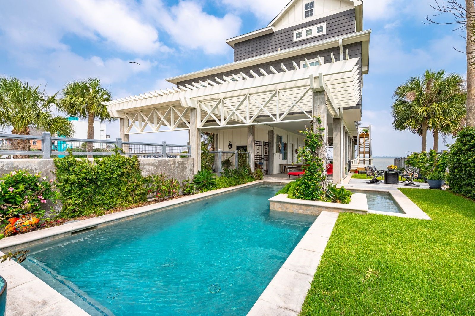 Plunge Into Summer 2026! Perfectly positioned waterfront home in Tiki Island with private heated swimming pool, fenced yard and extensive outdoor living space. Plunge Into Summer 2026! Perfectly positioned waterfront home in Tiki Island with private heated swimming pool, fenced yard and extensive outdoor living space.