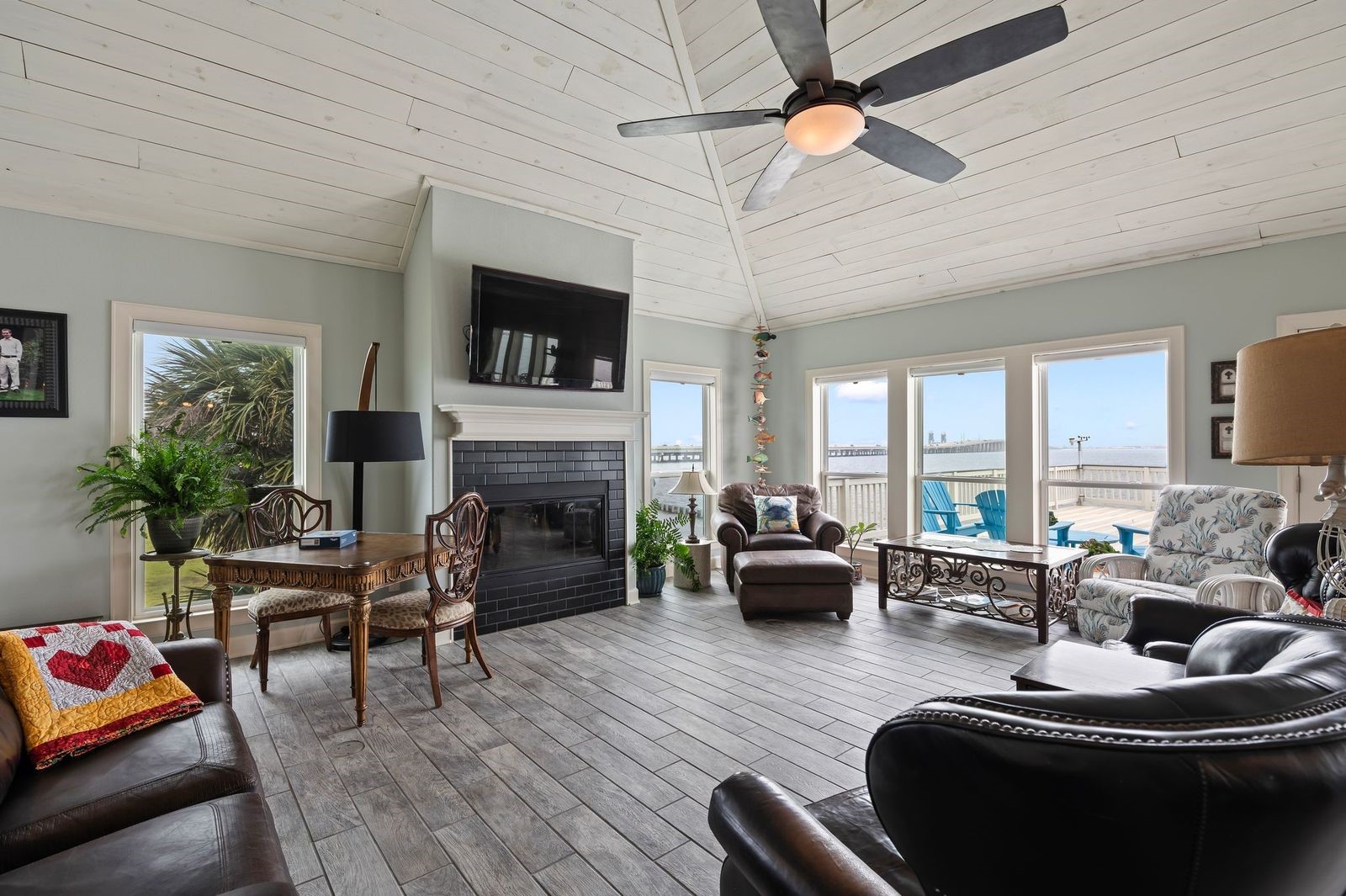 Grand Living Spaces With Waterviews!  Spacious living area with soaring cedar plank ceilings, fireplace and coastal wood-looking ceramic tile flooring.