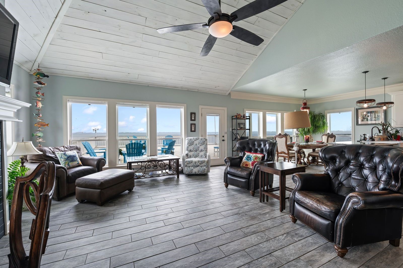 Character Filled Residence with Breathtaking Views and Wall-of-Windows! Ceramic tile flooring and custom cedar plank soaring ceiling.