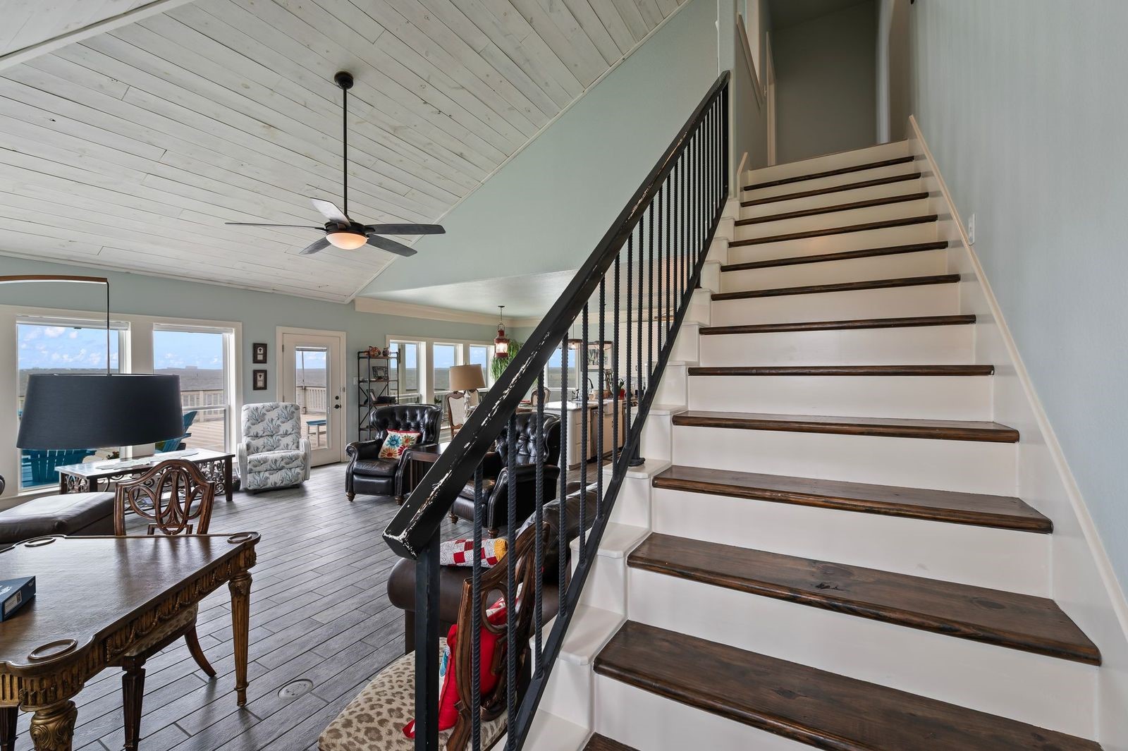 Comfortable, Quiet, Luxury!  Staircase leading to 2nd level features solid wood flooring and wrought iron railing.