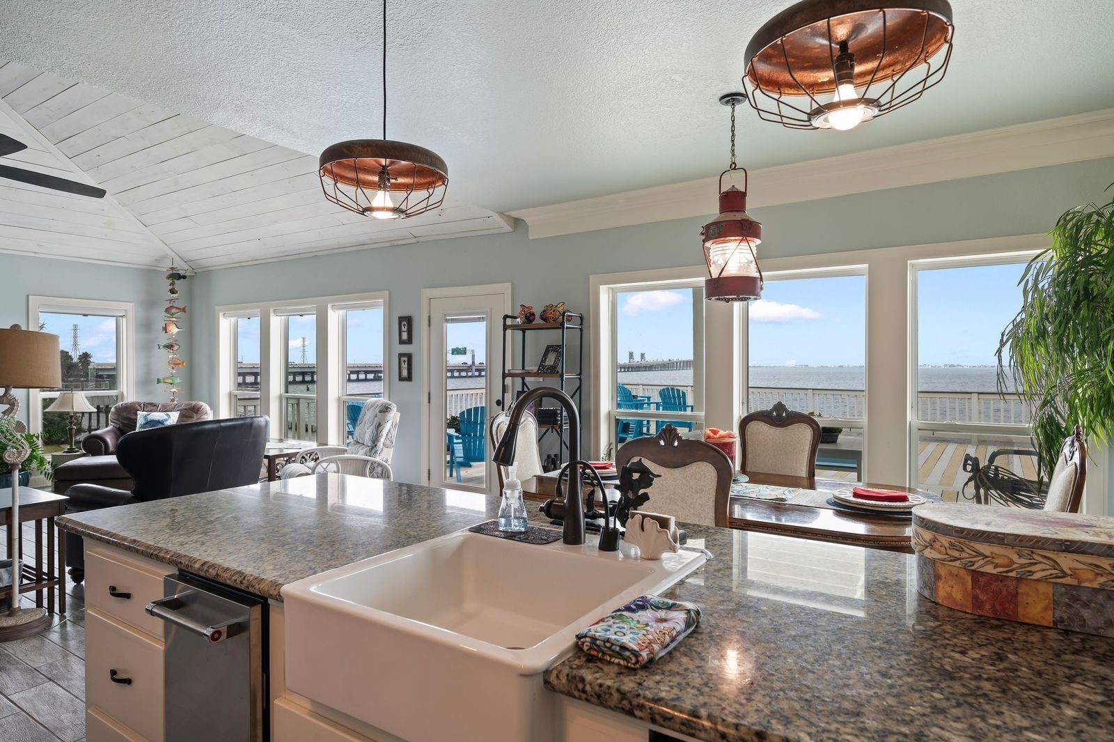Sophisticated & Modern with Unlimited Water Views!  Granite counter tops with large farmer's sink and custom coastal light fixtures.