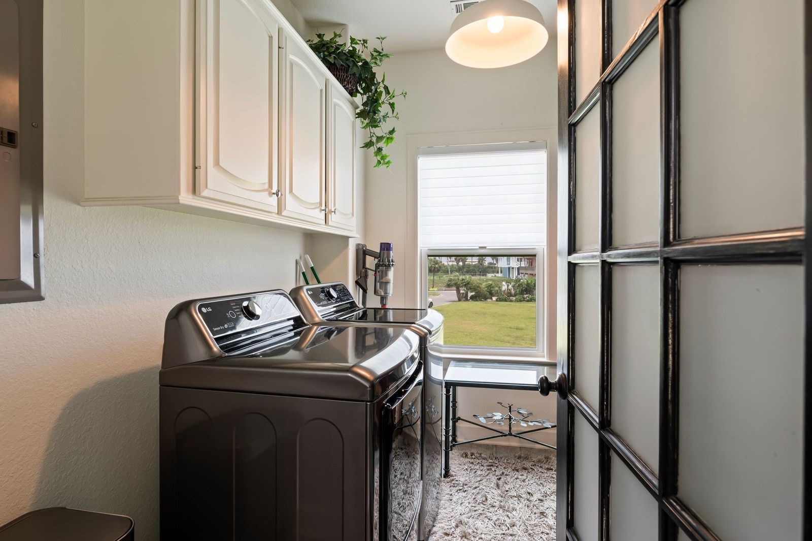 Space & Style!  Large laundry room with storage cabinets.
