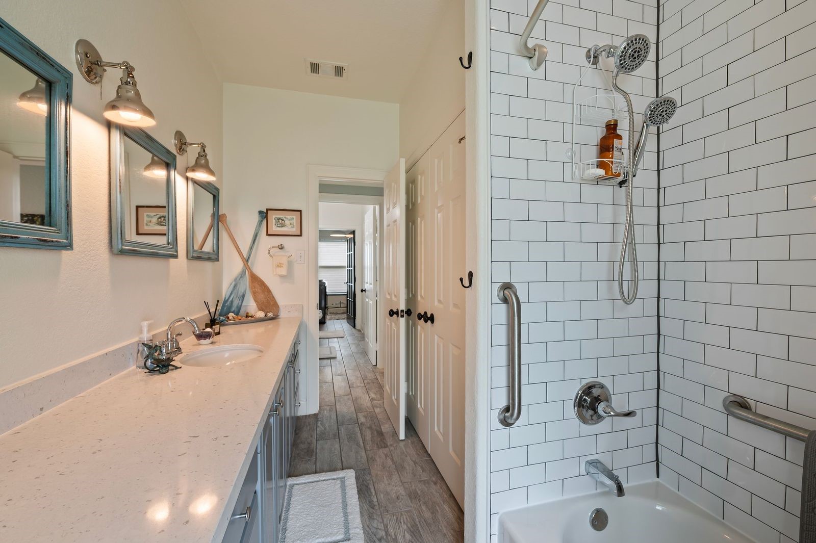 Meticulously Renovated!  Full secondary bathroom features custom fixtures, counters and subway tile surrounding the shower/tub combination.