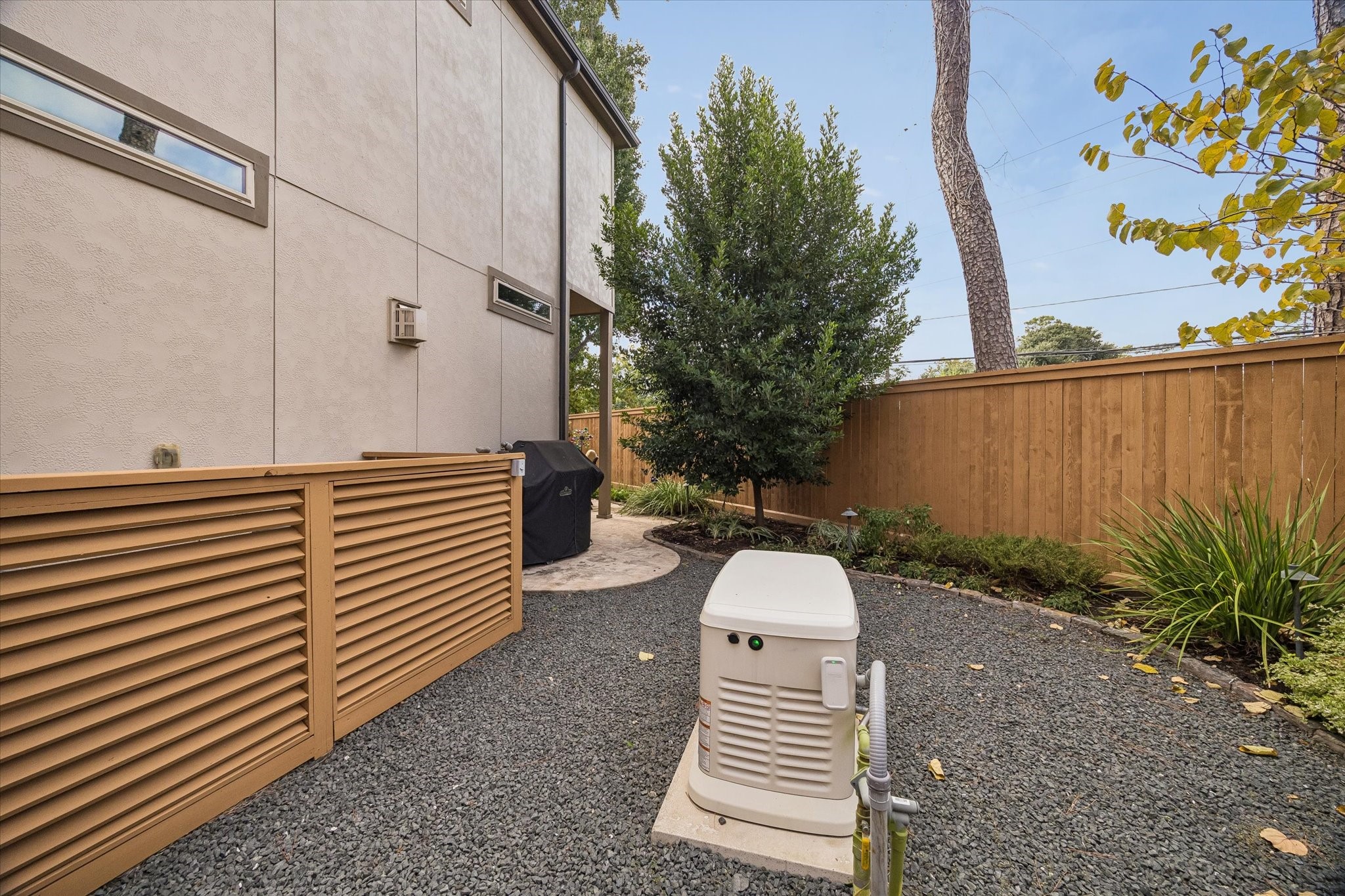 Extra side yard with grilling area and generator.