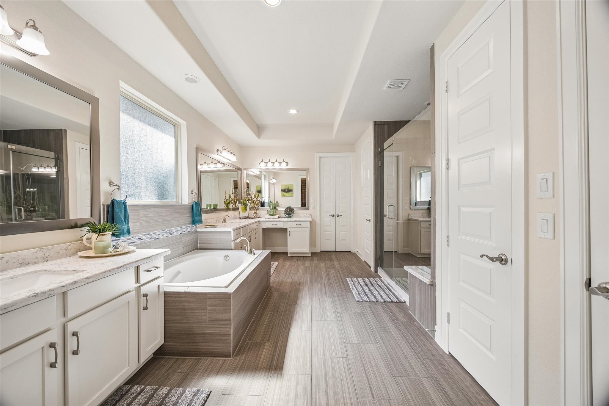Luxurious primary bathroom with oversized walk-in shower on right.