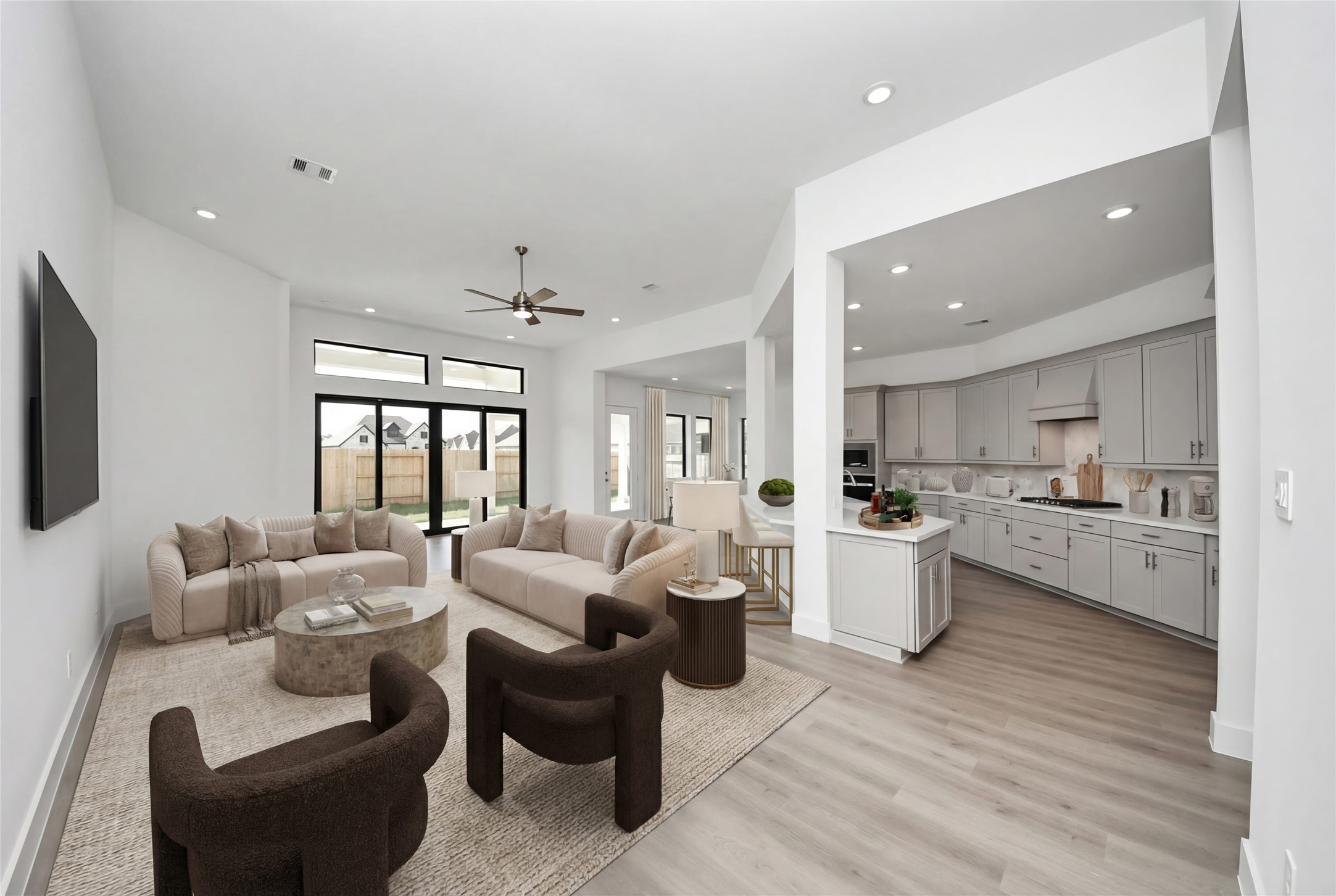 Walking into this expansive open-concept space, one immediately feels a sense of grandeur and tranquility thanks to the soaring ceilings and an abundance of natural light streaming through the massive glass slider.