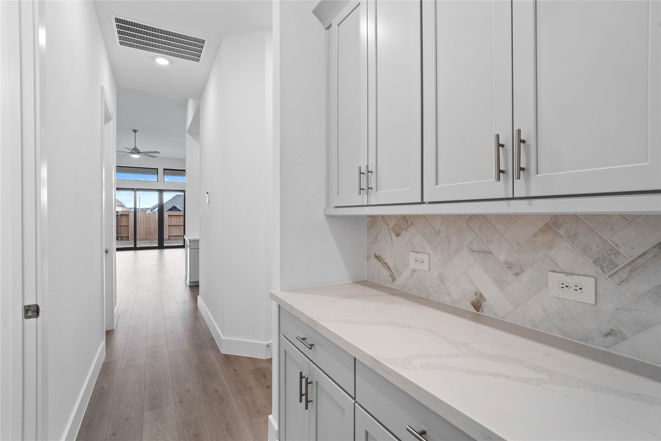 This gorgeous butler pantry area is perfect for quick access when entertaining friends and family. With a granite countertop and stained cabinetry, this will make your gatherings a breeze to keep the entertainment flowing!