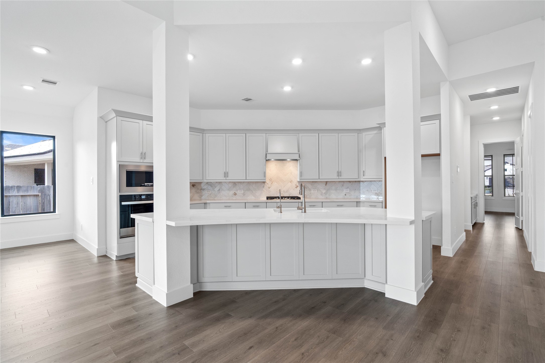 Grand view of this stunning gourmet kitchen which serves as the true heart of the home. Its open-concept layout seamlessly connects to the living spaces for effortless entertaining.