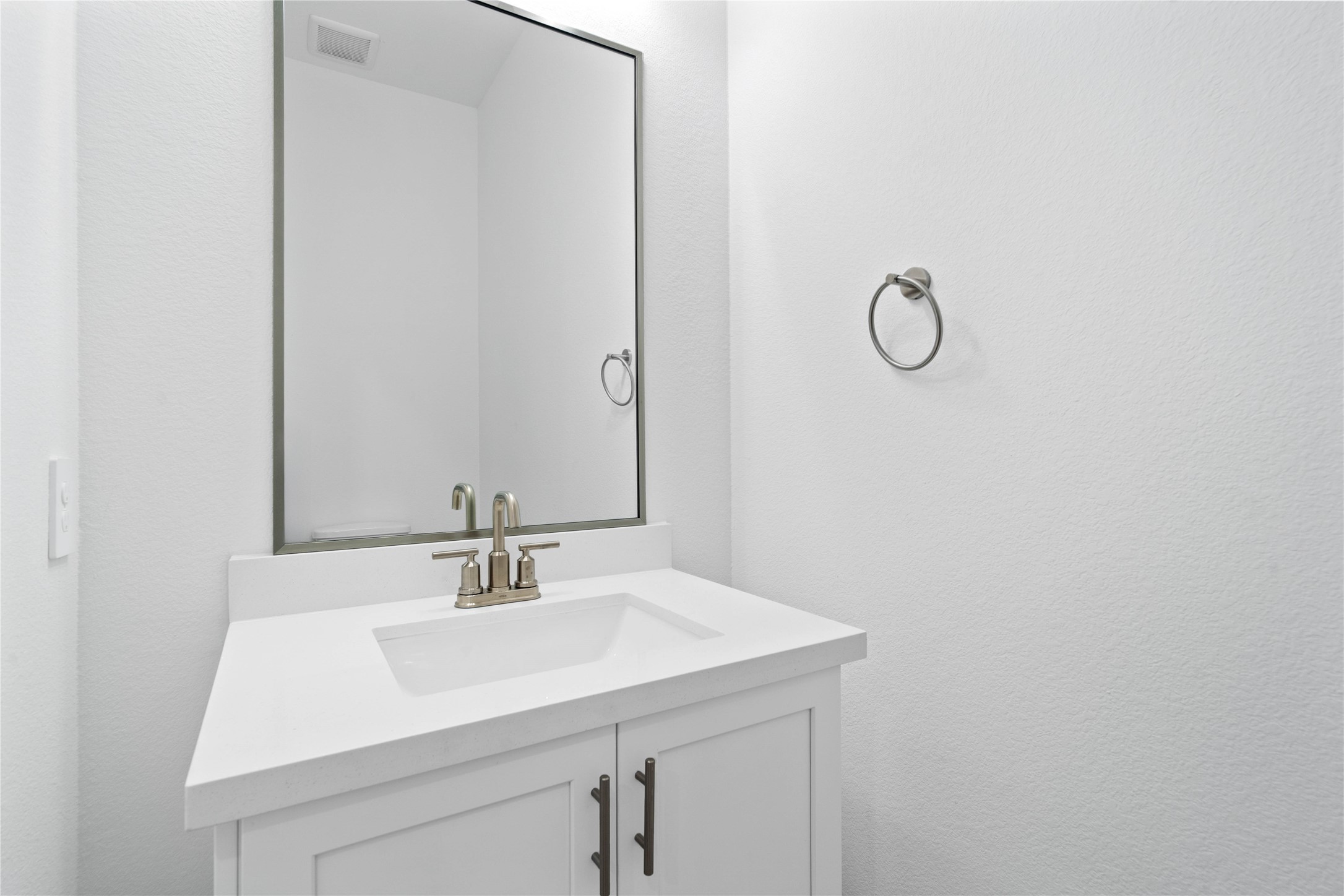 The powder bath features a stylish vanity and a clean, modern design.