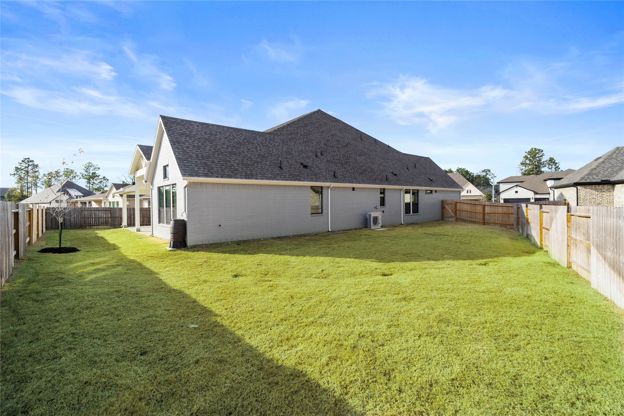 The spacious side yard is uniquely functional, providing ample room for a private dog run, a secluded garden, or convenient out-of-sight storage for larger items.