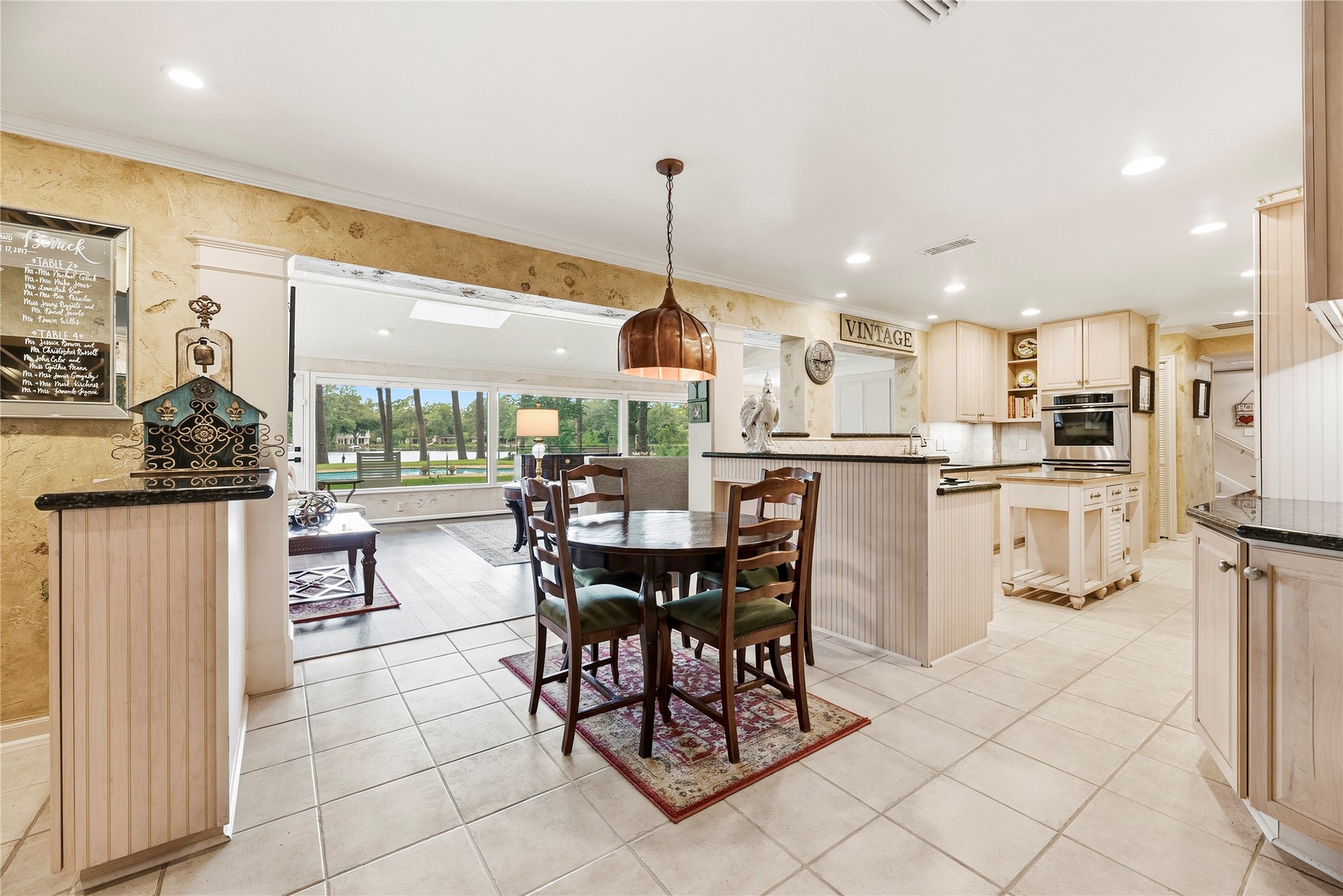 Picturesque lakefront views from the breakfast nook complete with an antique light fixture.