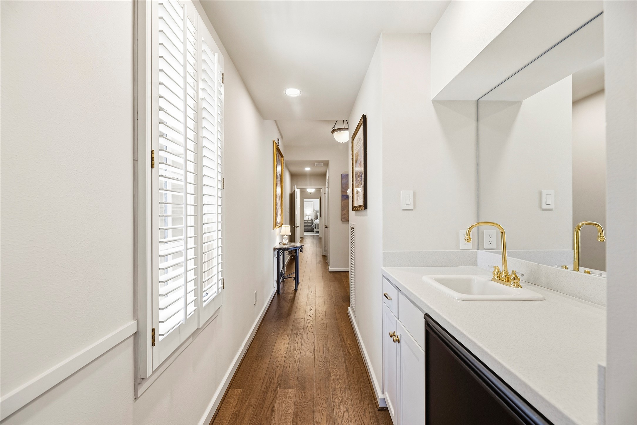 Hallway upstairs with a wet bar next to the game room, and the hall leads to the upstairs bedrooms.
