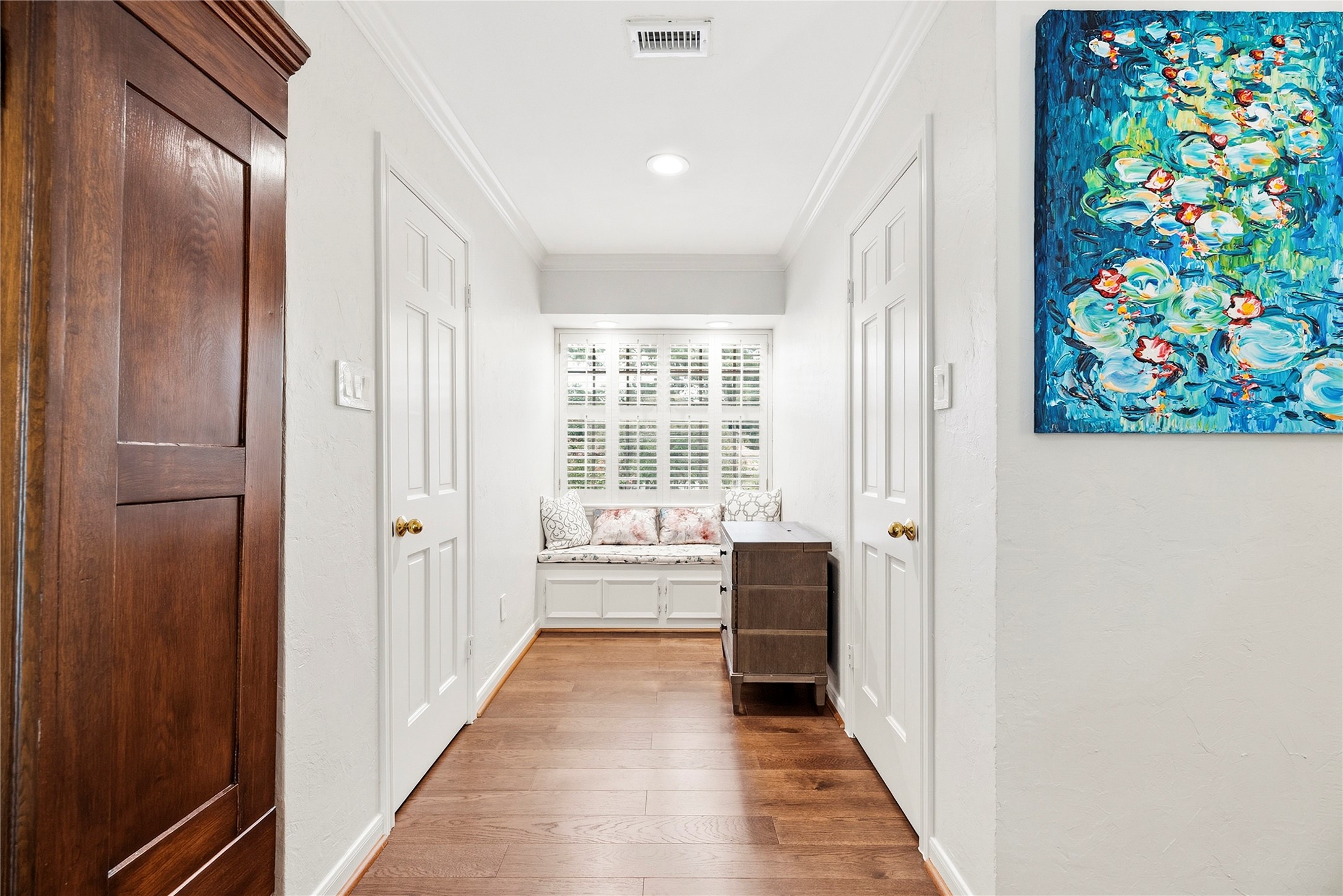 Split closets in the primary suite with a sitting bench.
