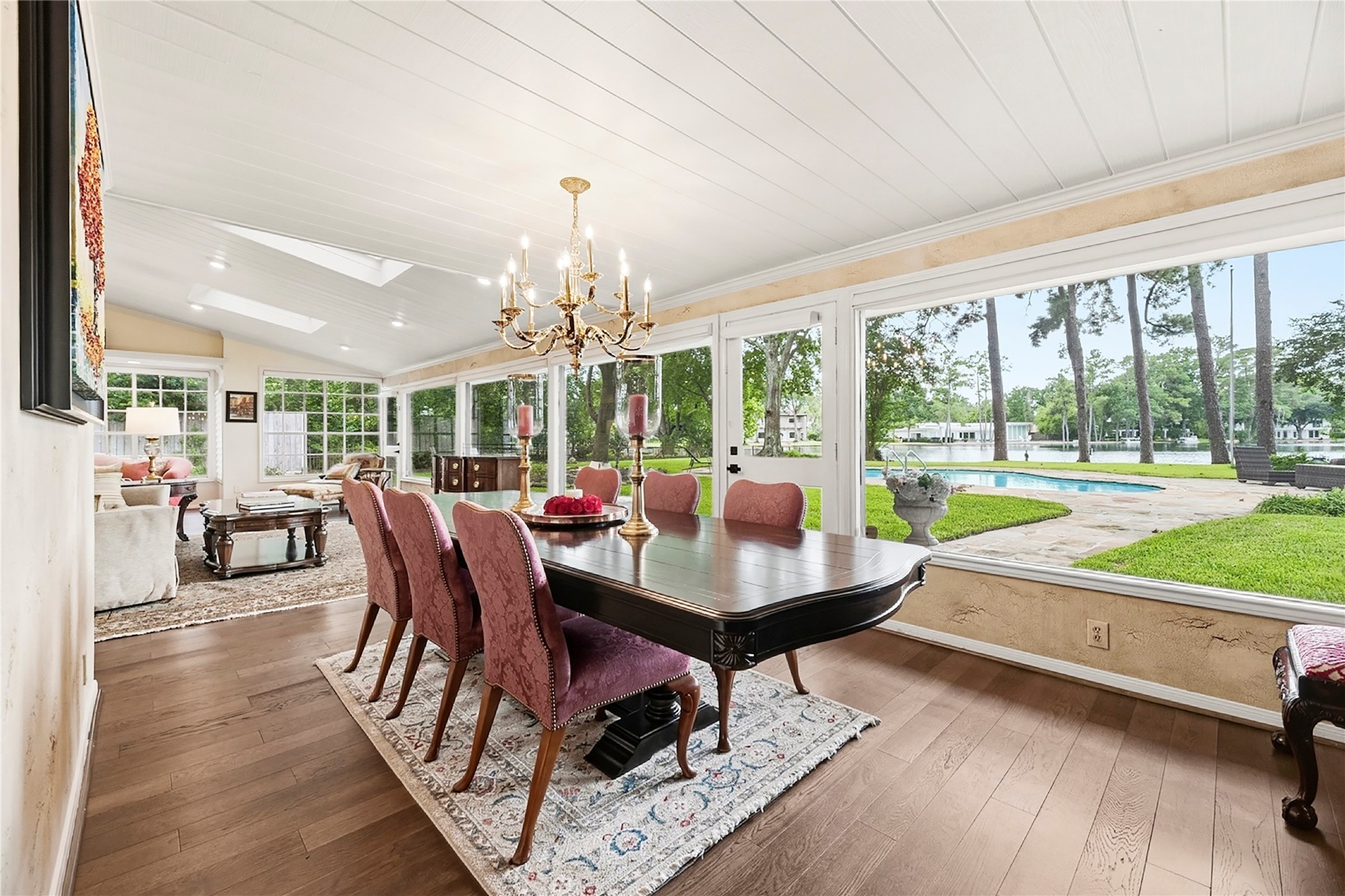 Incredible formal dining space at the heart of the home, with a wall of windows overlooking 105' of private lakefront.
