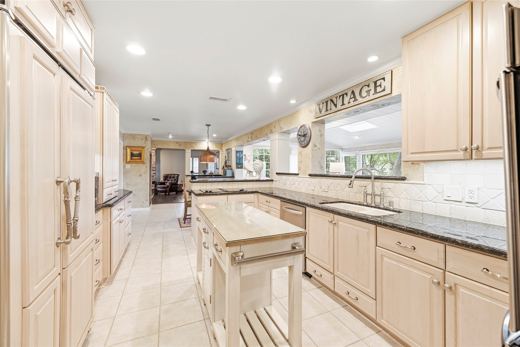 Timeless kitchen complete with granite countertops, Thermador double ovens, wood-paneled sub-zero refrigerator, recessed lights and more.