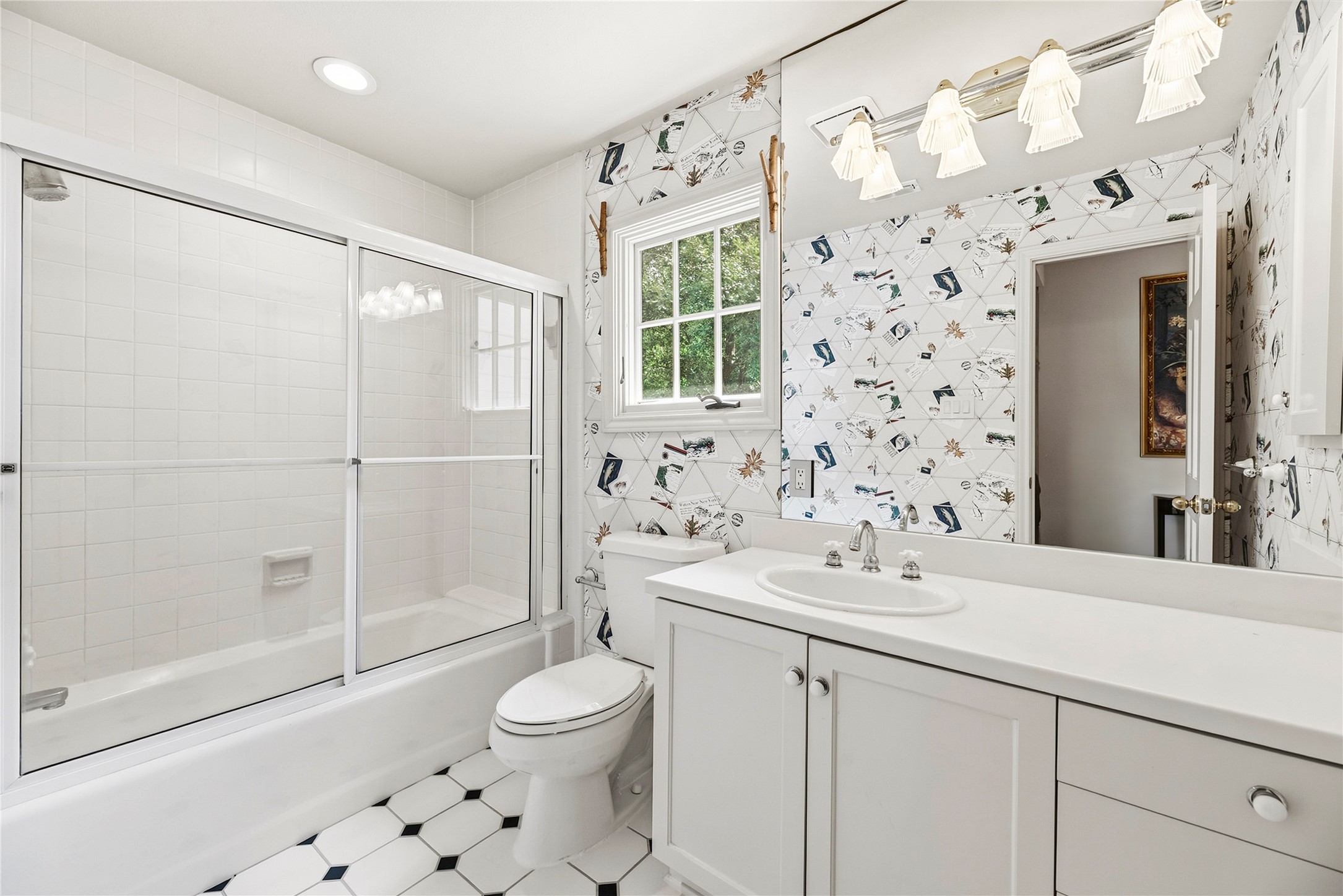 Secondary bathroom with a shower/tub combo + vanity.