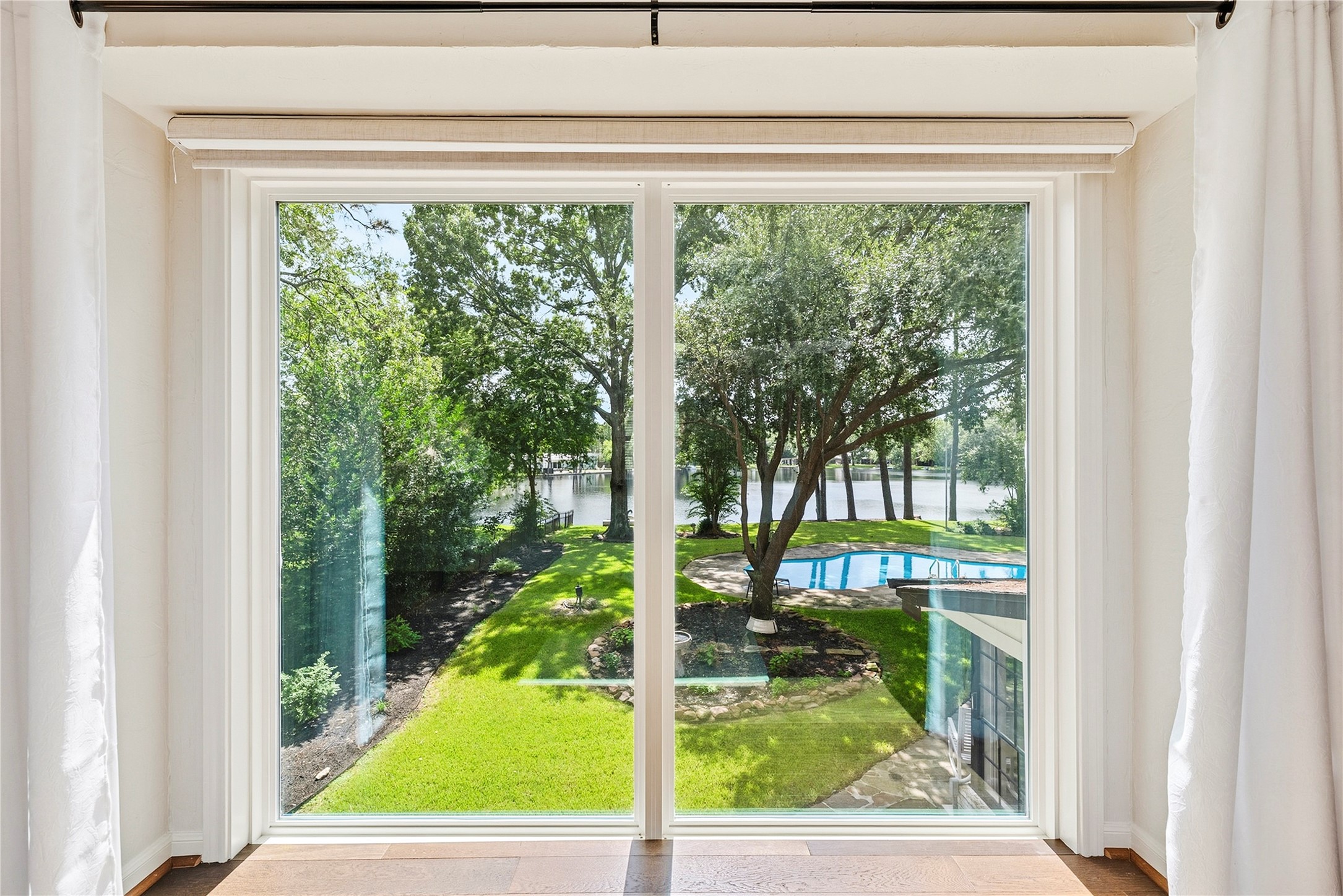 Beautiful oversized windows with lakefront views from the primary suite.