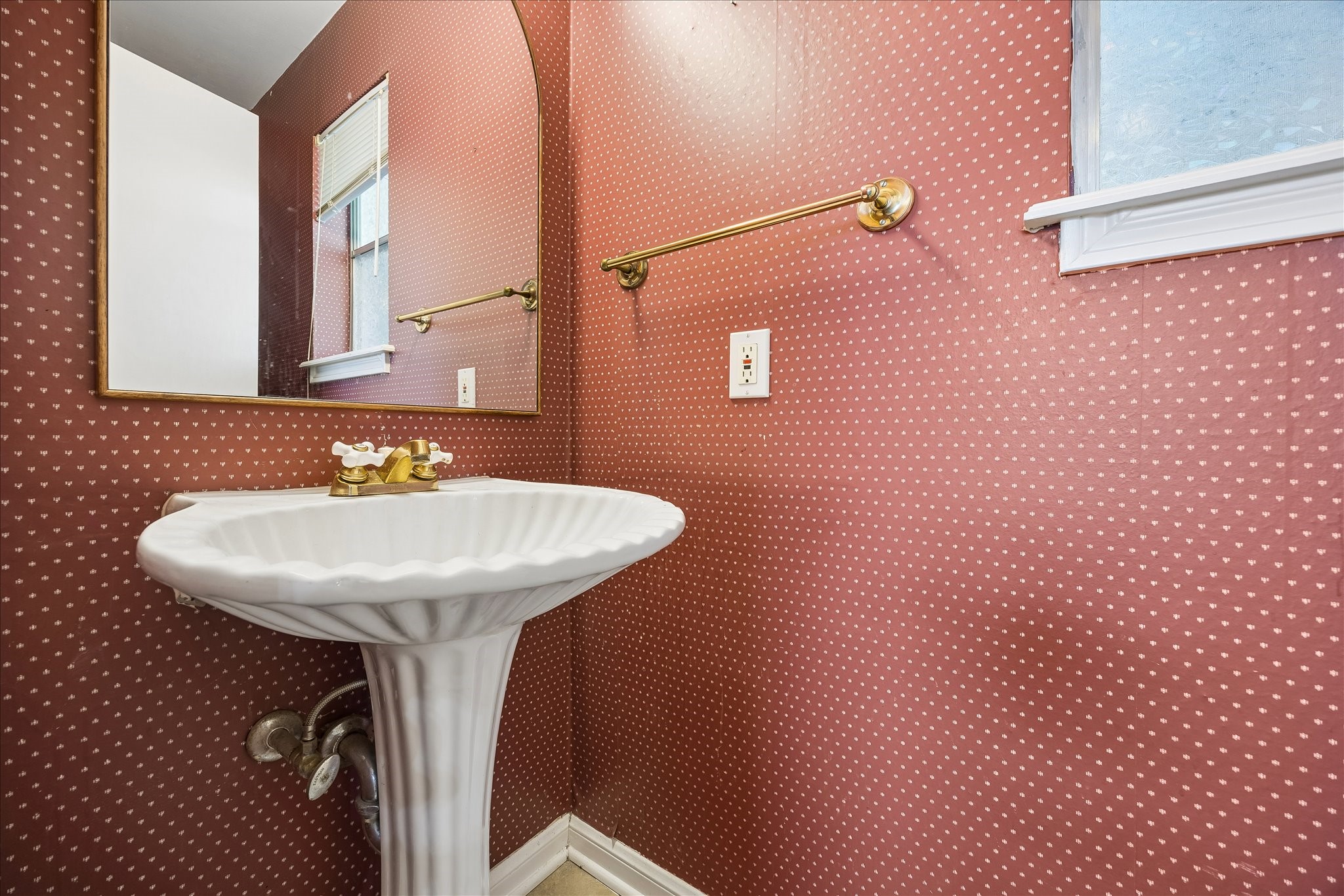 The half bath is off the utility room in the back of the home.
