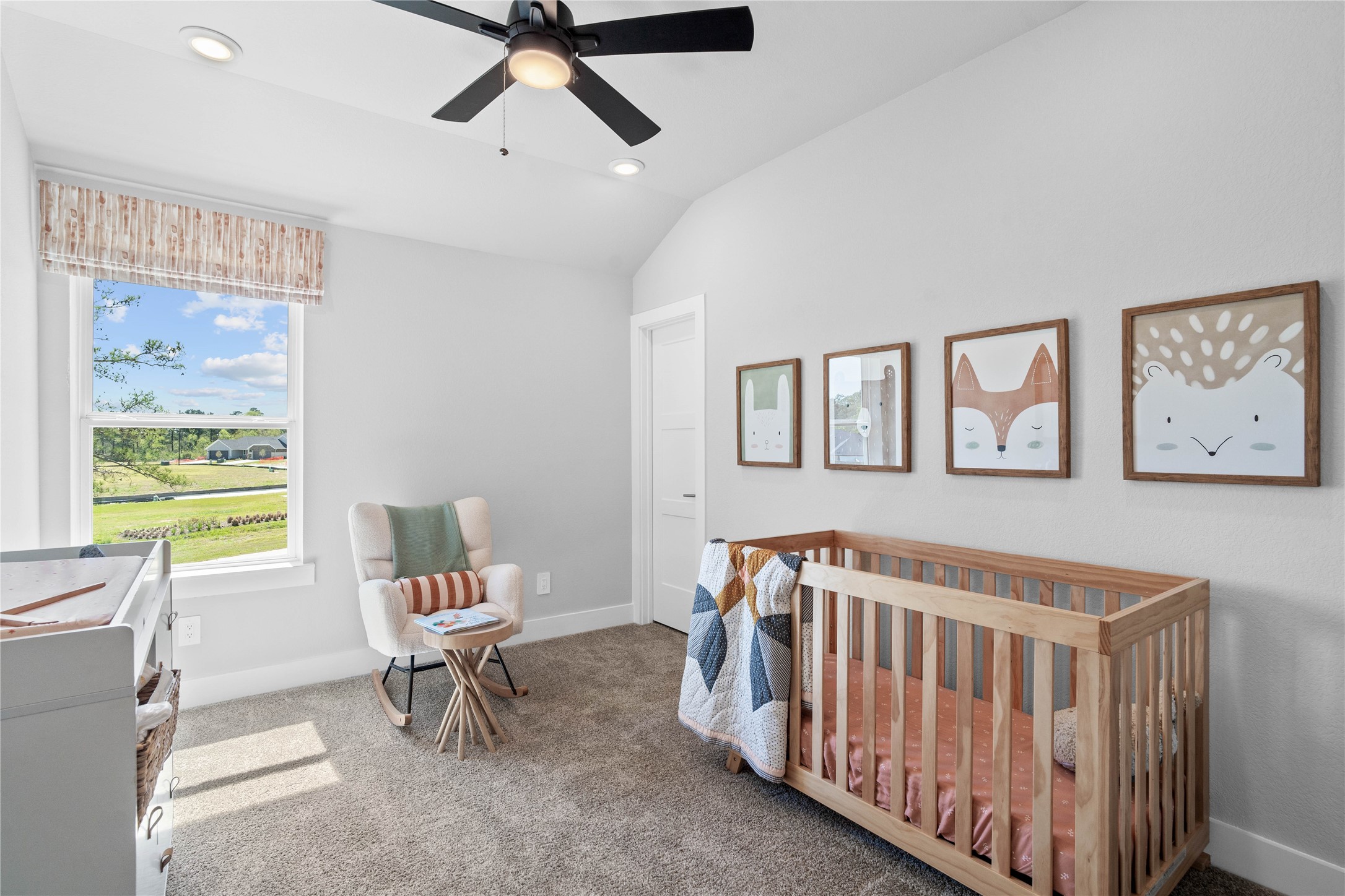 Step into this bright and airy secondary bedroom! It offers a tranquil space to unwind. The large window illuminates the room's sloped ceiling and neutral tones, creating a cheerful and airy environment. This room features a walk-in closet.