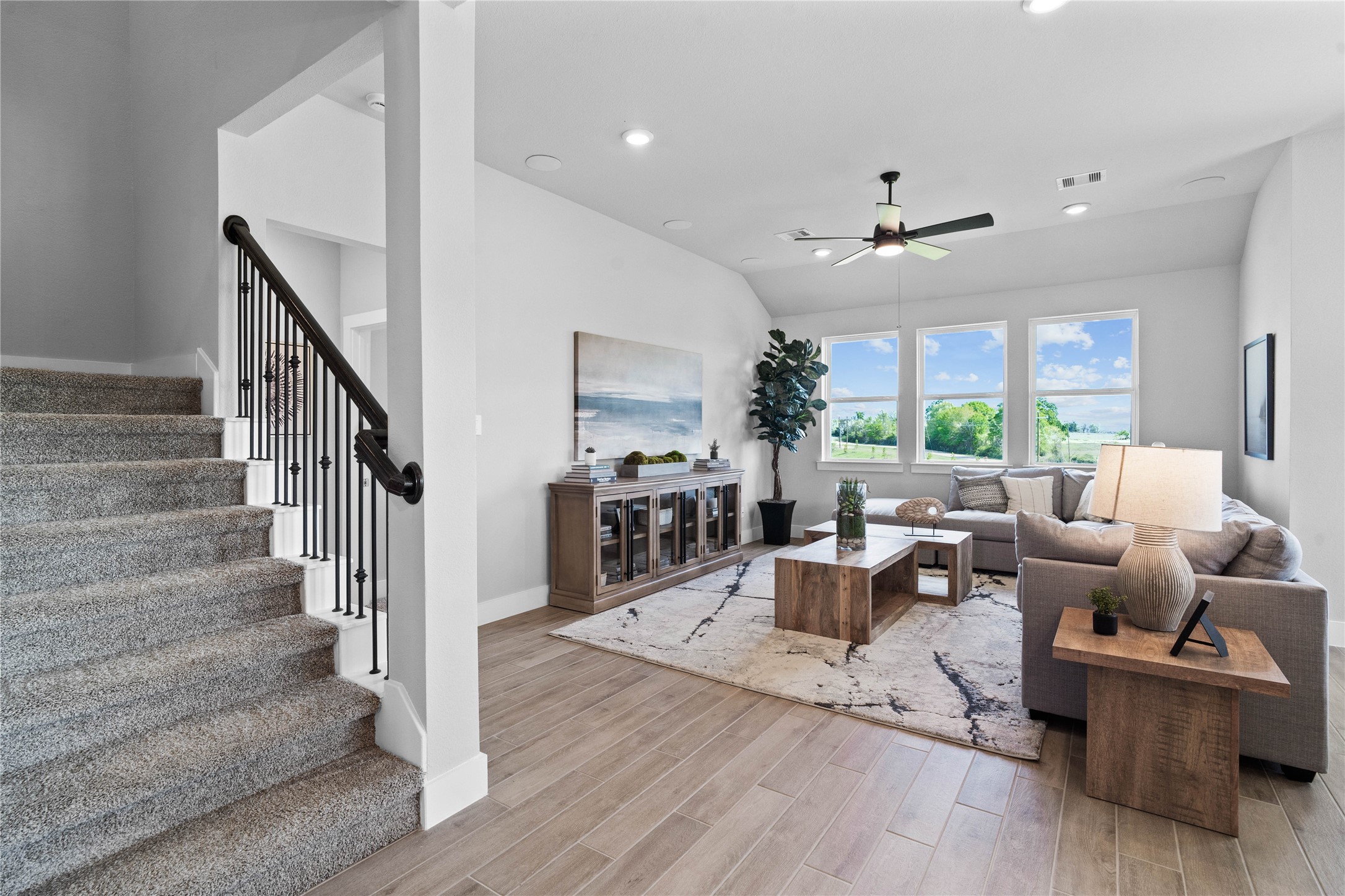 Just beyond the entryway, a radiant, open-concept Great Room unfolds, immediately establishing itself as the heart of the home and the ultimate gathering spot.