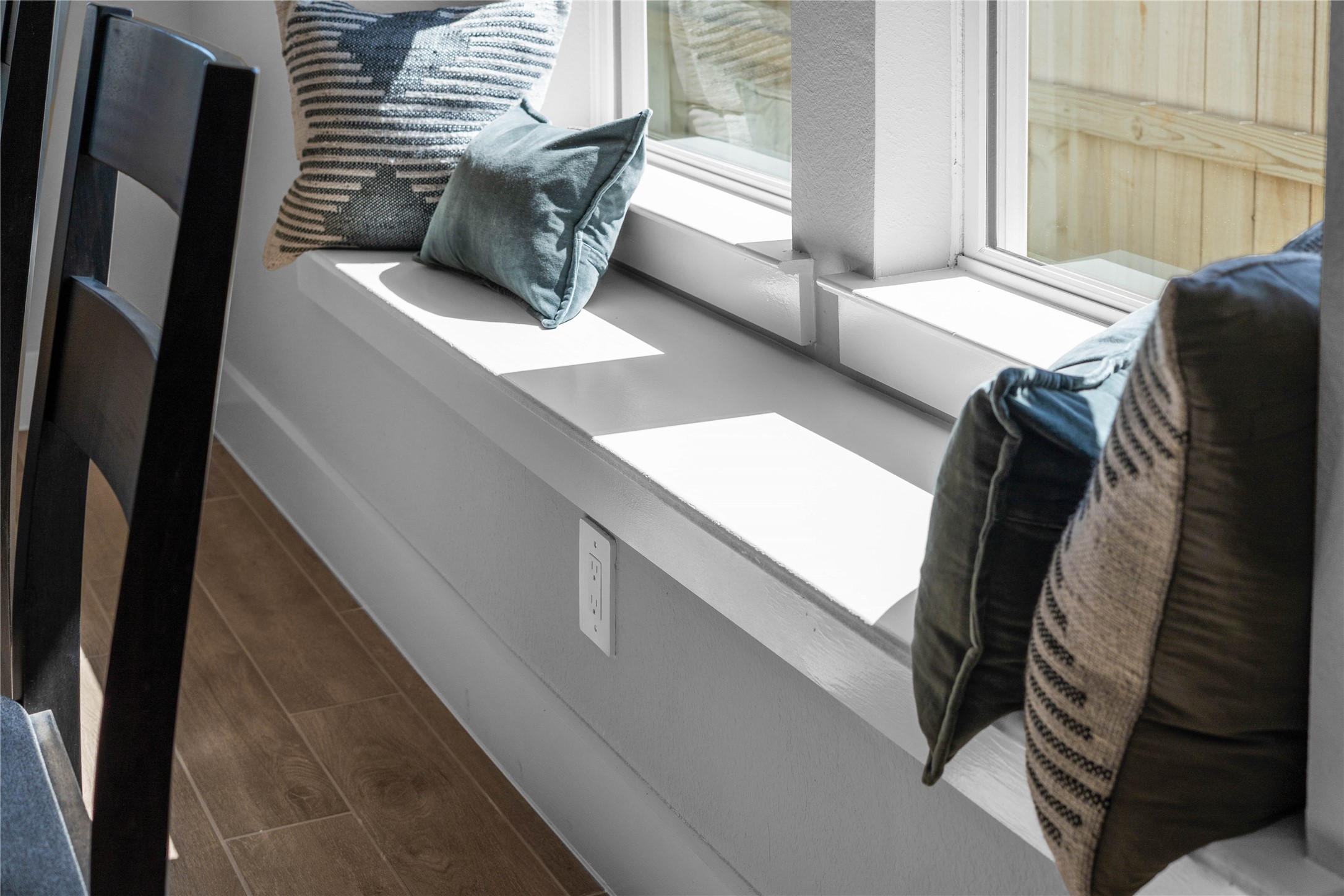 This window seat in the dining area is a key feature adding more seating or a relaxing spot to sit and get warm by the window while reading a book or sipping a morning coffee.