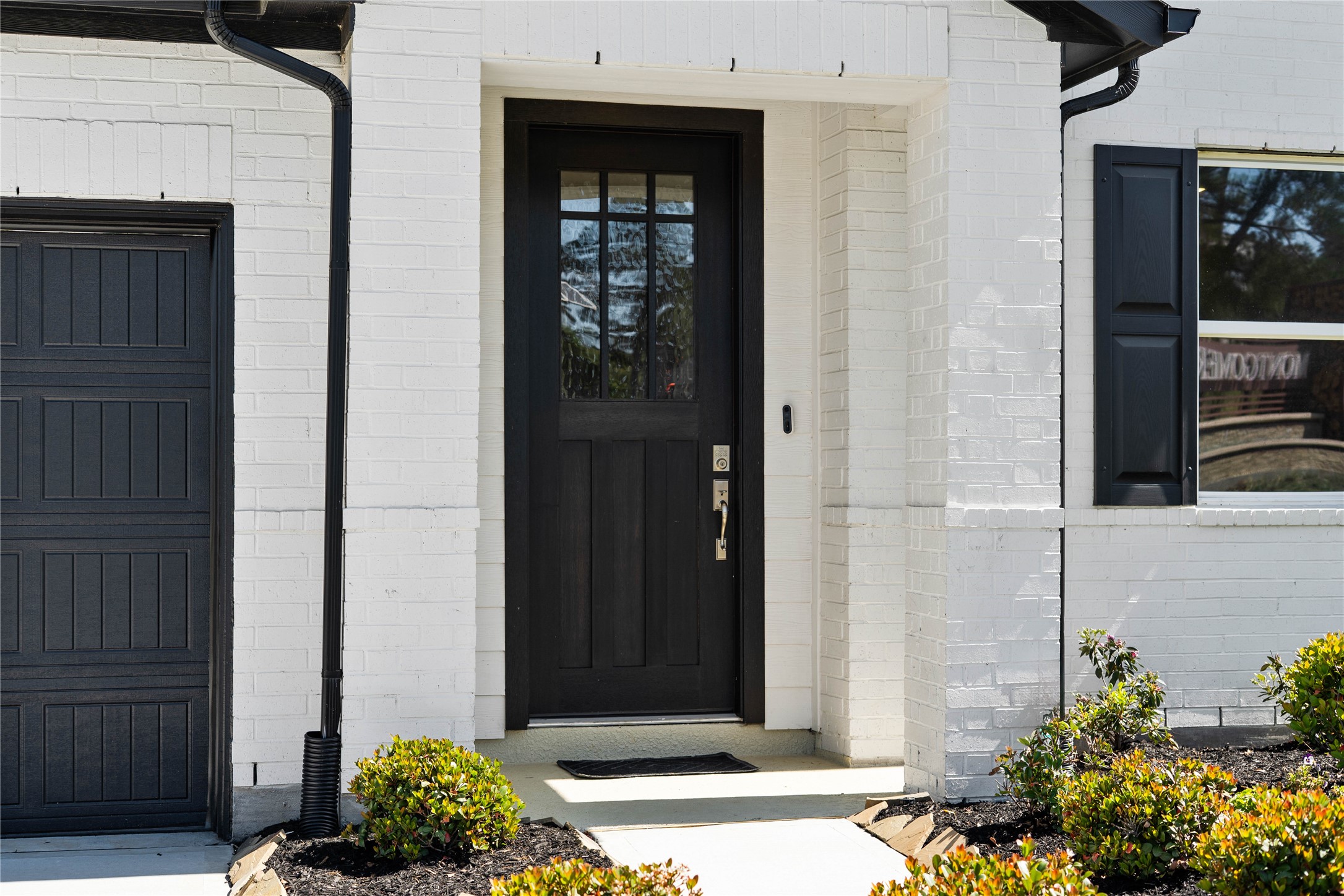 This home is modern elegance with a timeless white brick and siding exterior and high quality entry door.