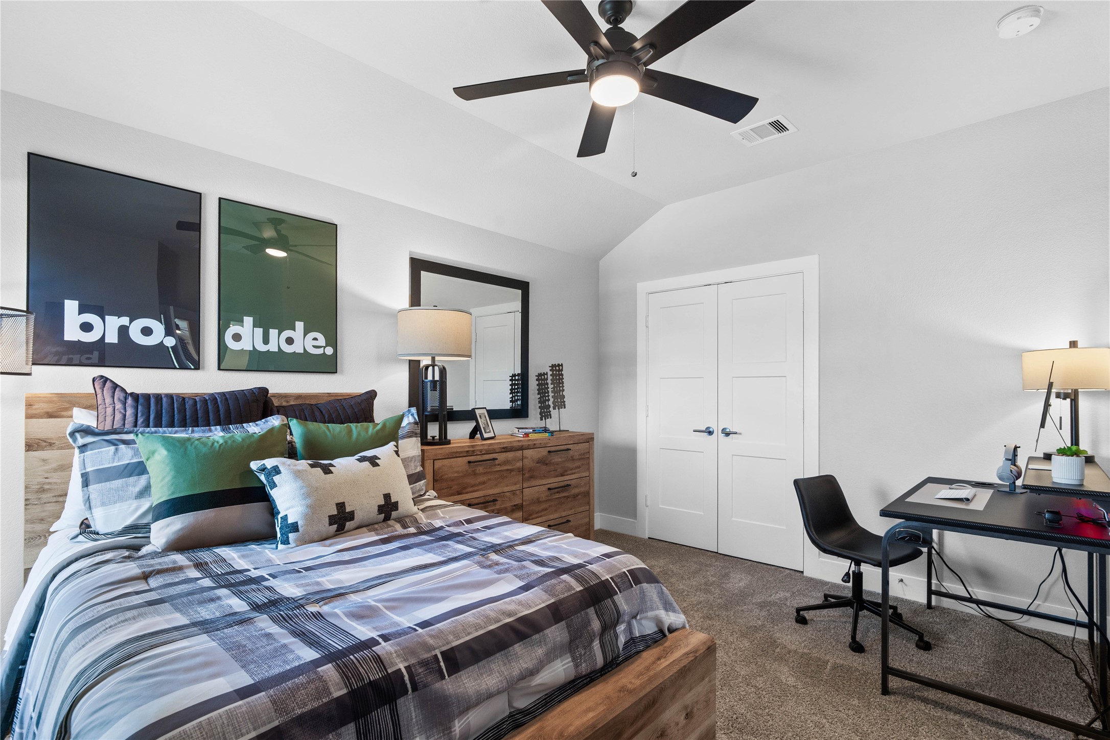 This cozy secondary bedroom offers plush soft carpeting, neutral walls ready for personalization, a sun-filled window with fitted blinds, sloped ceilings, and an ample sized closet.