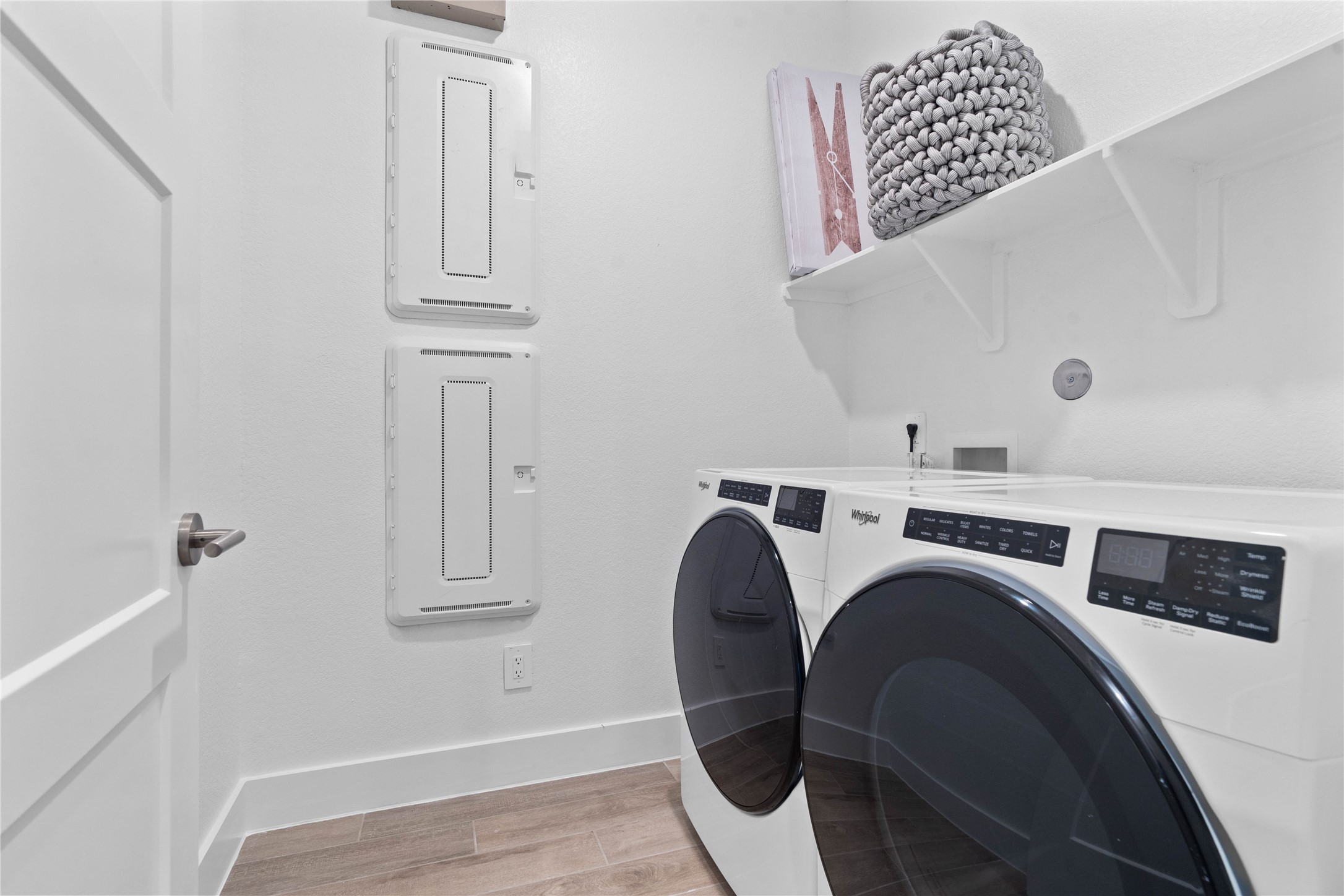 This dedicated laundry room comes equipped with a washer and dryer set, ready for immediate use.
