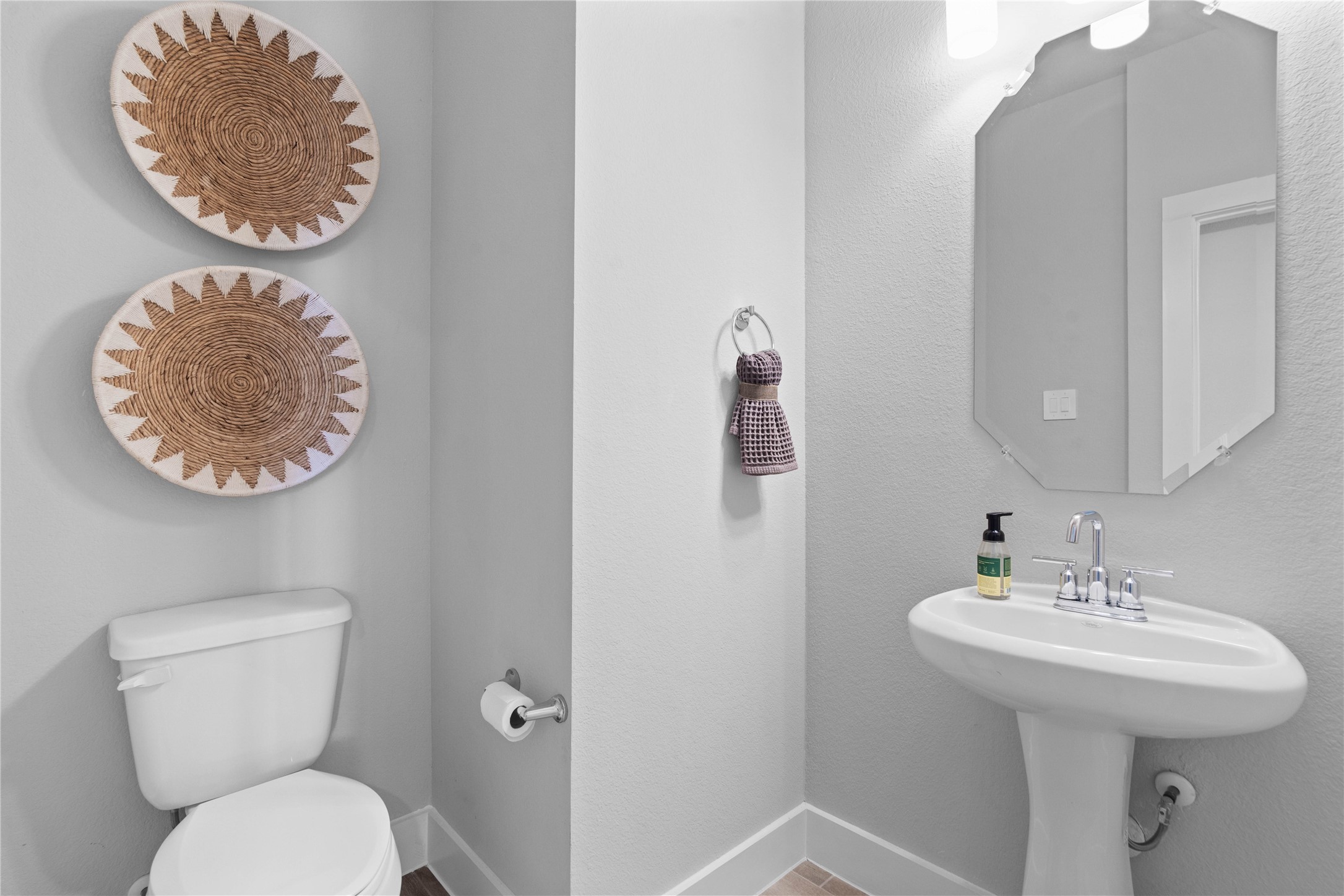 Strategically located on the main level, this half-bath allows guests to freshen up easily without having to navigate through the private areas of the home, such as the bedrooms or personal full bathrooms.