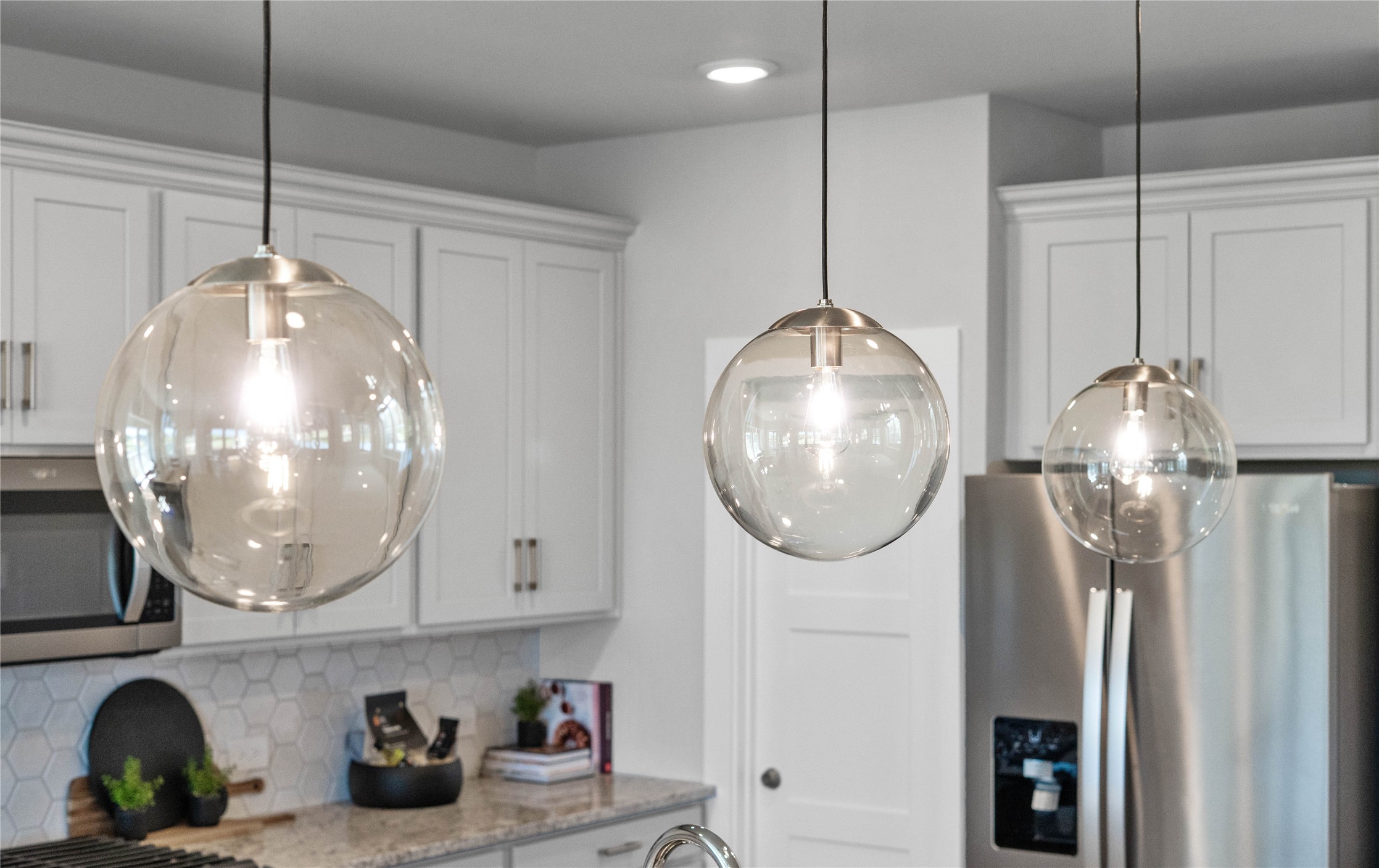 Atwell Pendant Brushed Nickel lights that hang over the kitchen island.