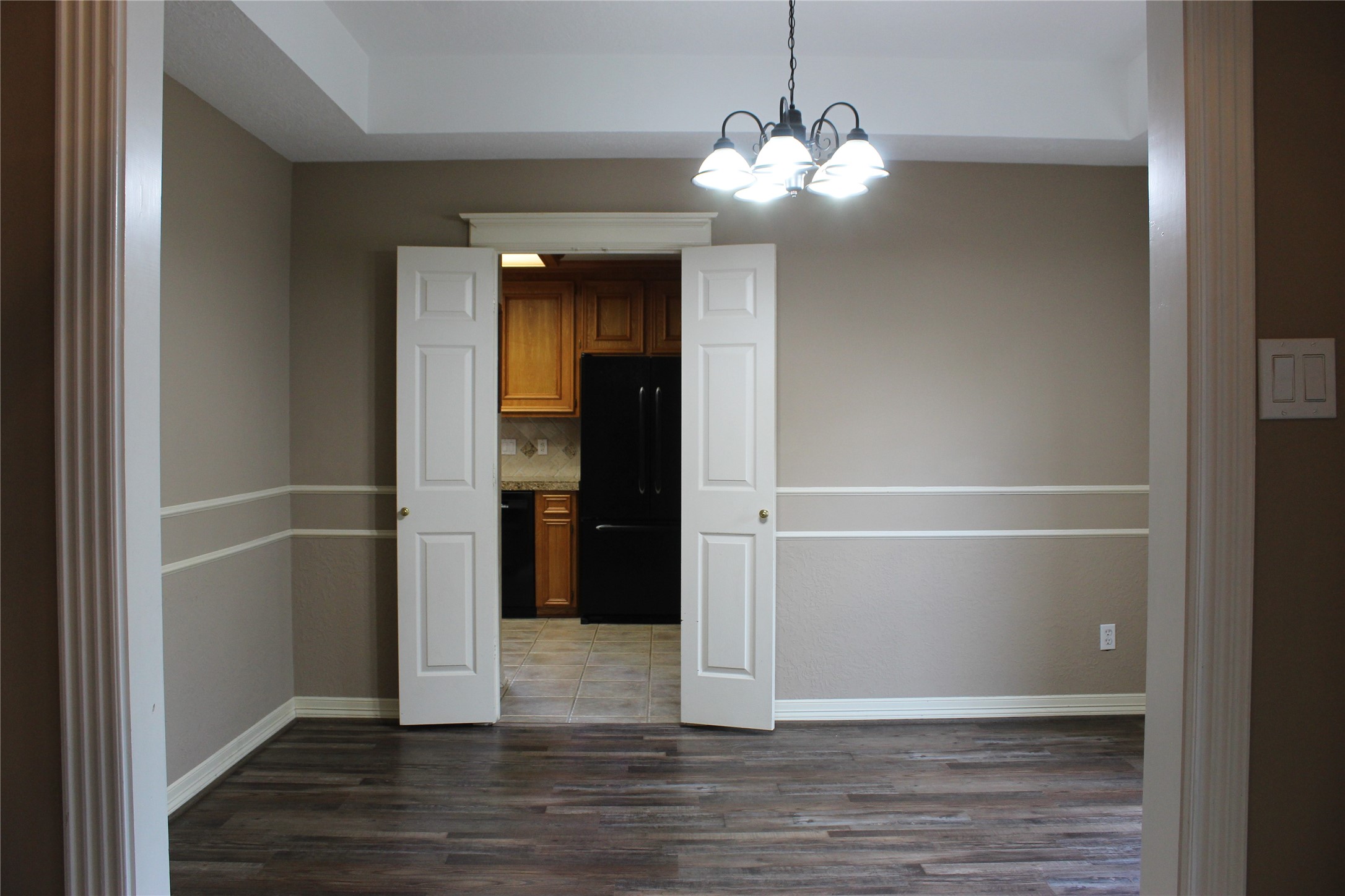 Dining room showing double doors to kitchen