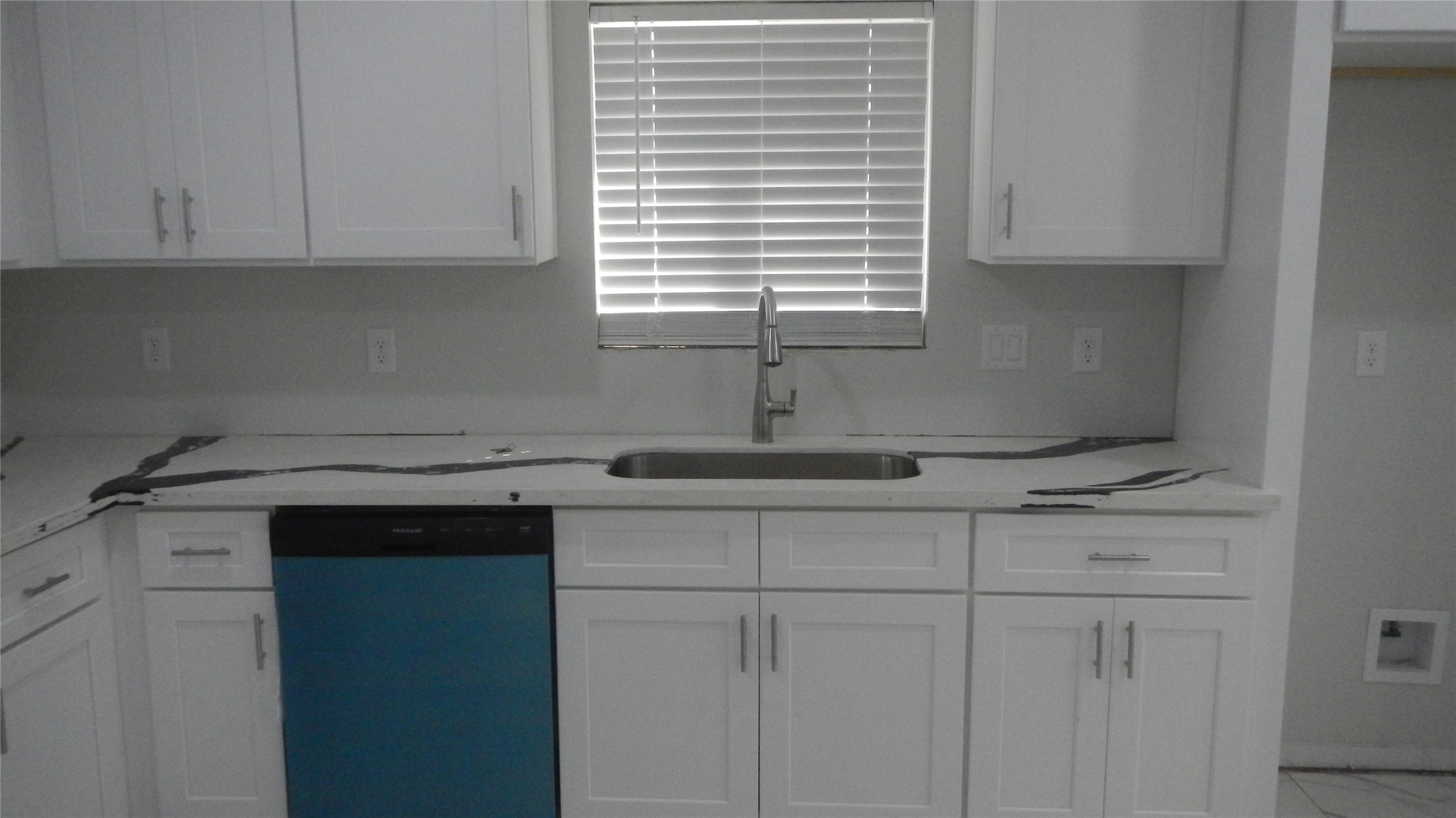 Pull down kitchen faucet, new dishwasher, and elegant countertop