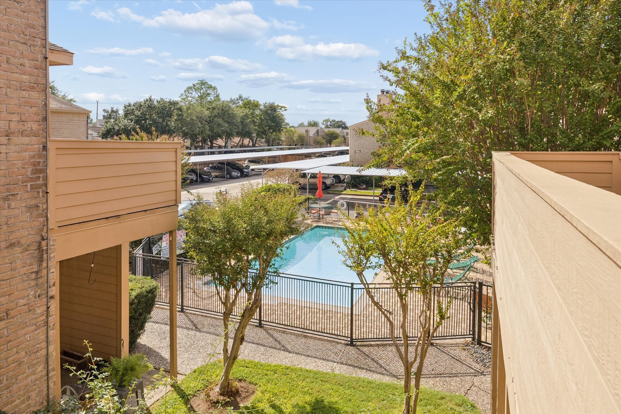 View from the unit overlooking the community pool and landscaped courtyard, creating a pleasant resort-style setting.